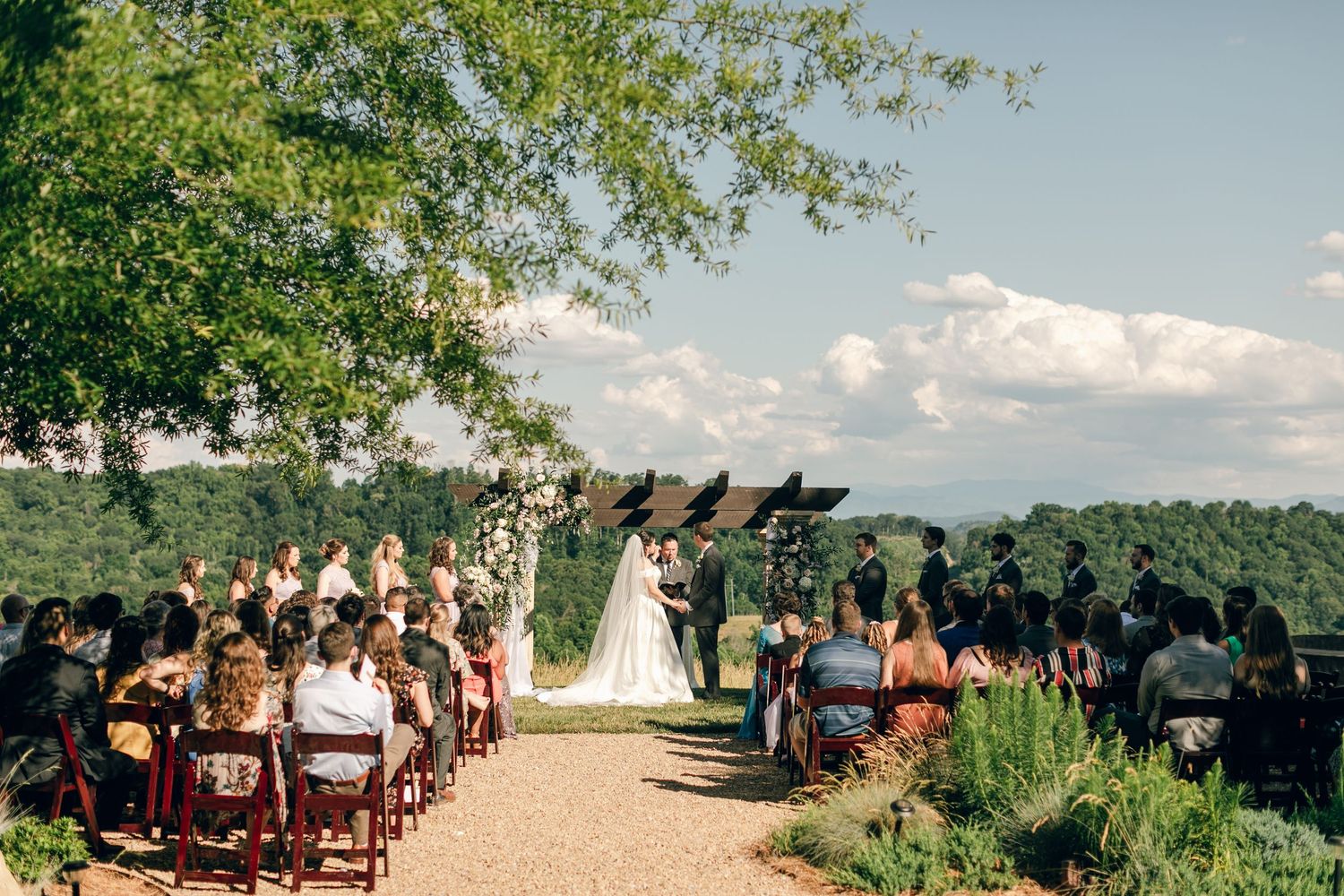 Bride and groom standing in front of friends and family during their wedding ceremony at Chateau Selah wedding in Tennessee.