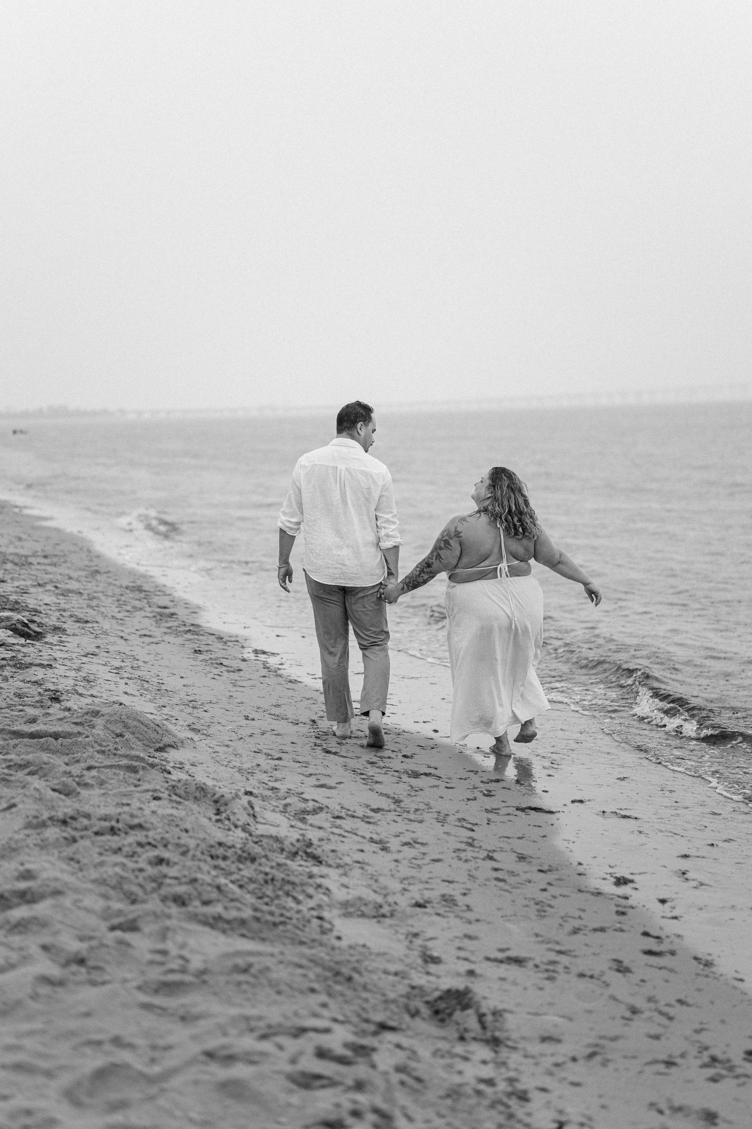 A romantic rainy engagement session at Terrapin Nature Park in Maryland.