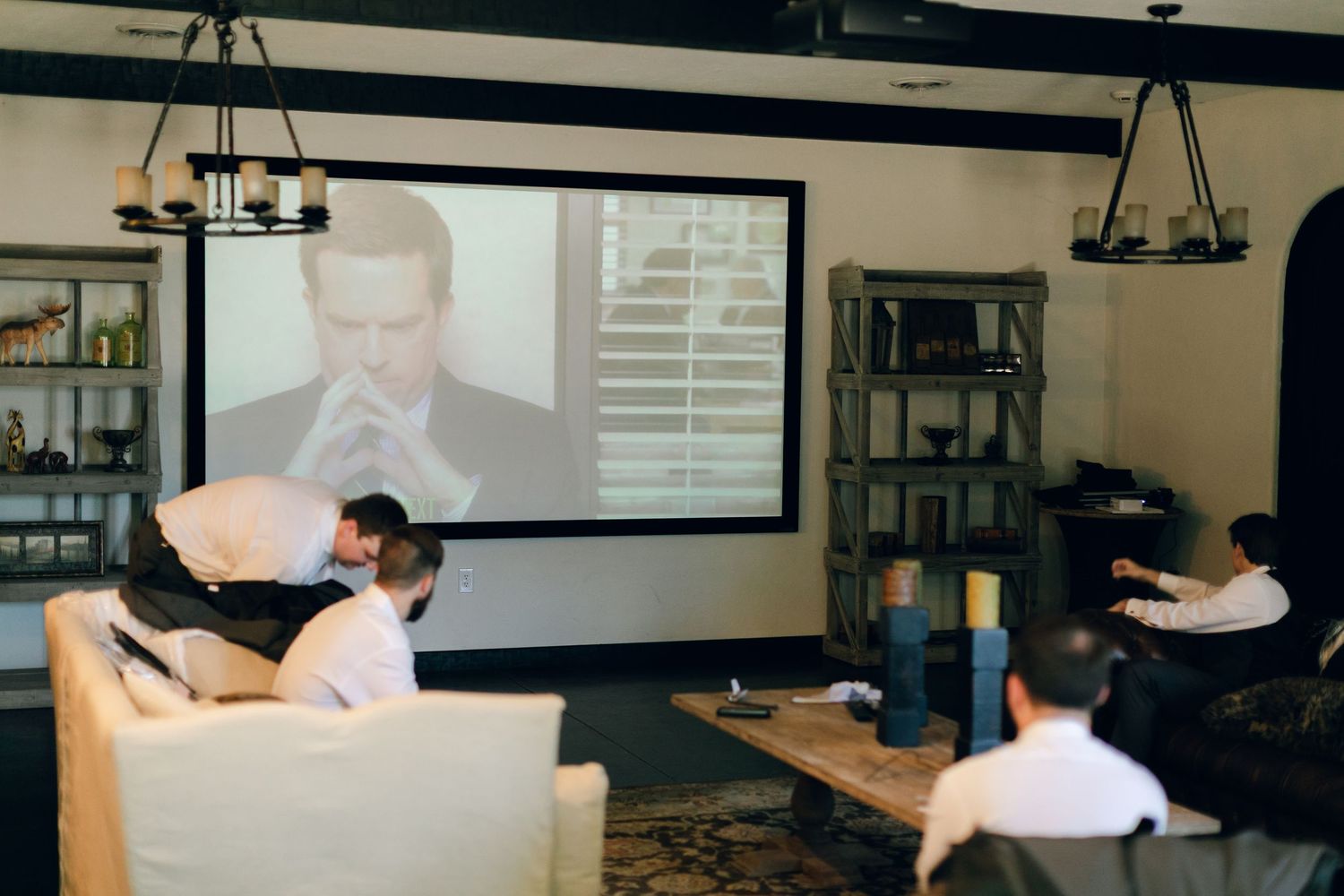 Groomsmen watching tv at Chateau Selah wedding in Tennessee.