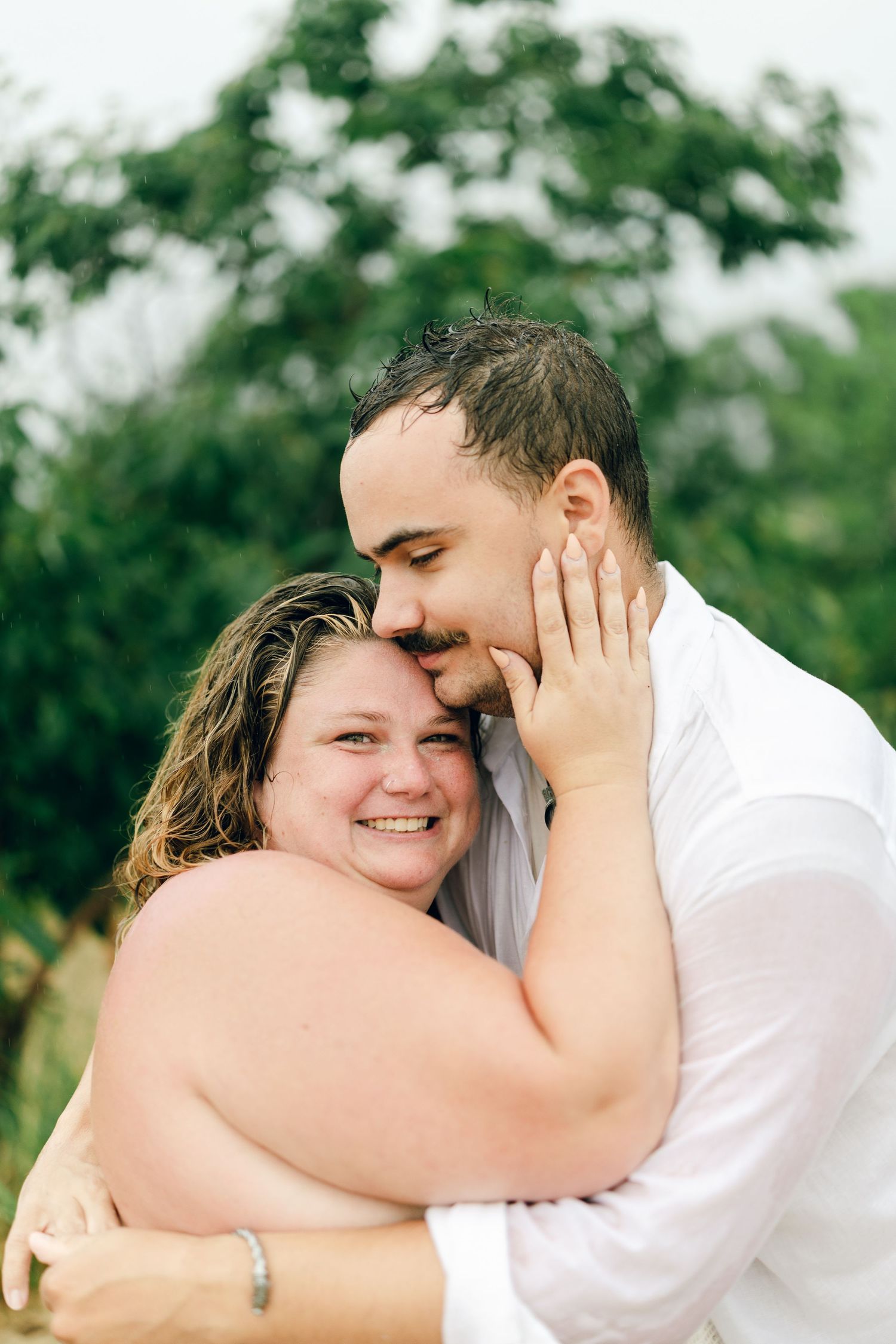 A romantic rainy engagement session at Terrapin Nature Park in Maryland.
