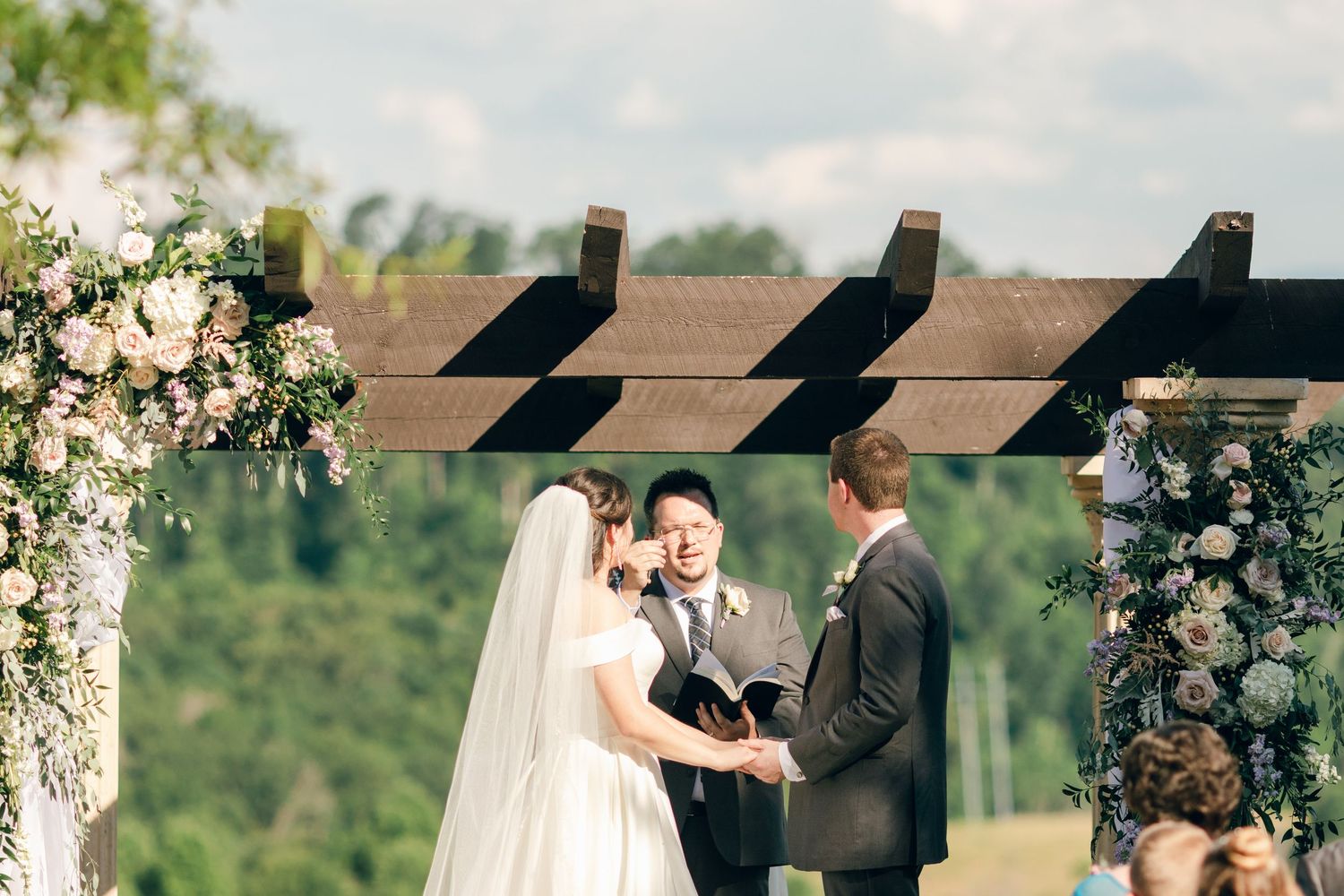 Bride and groom standing in front of friends and family during their wedding ceremony at Chateau Selah wedding in Tennessee.
