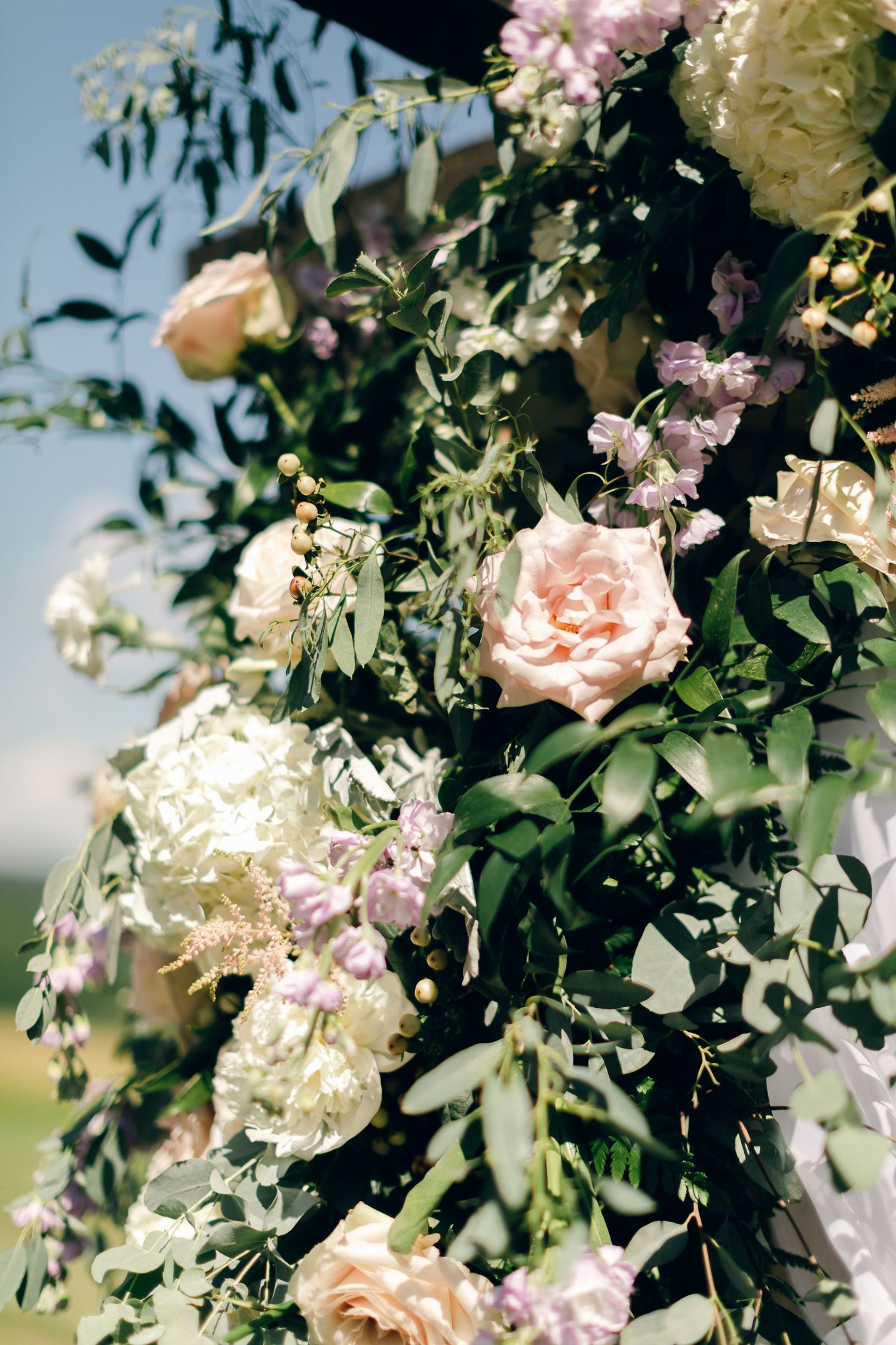 Soft white and pink florals decorating arbor at Chateau Selah wedding in Tennessee.