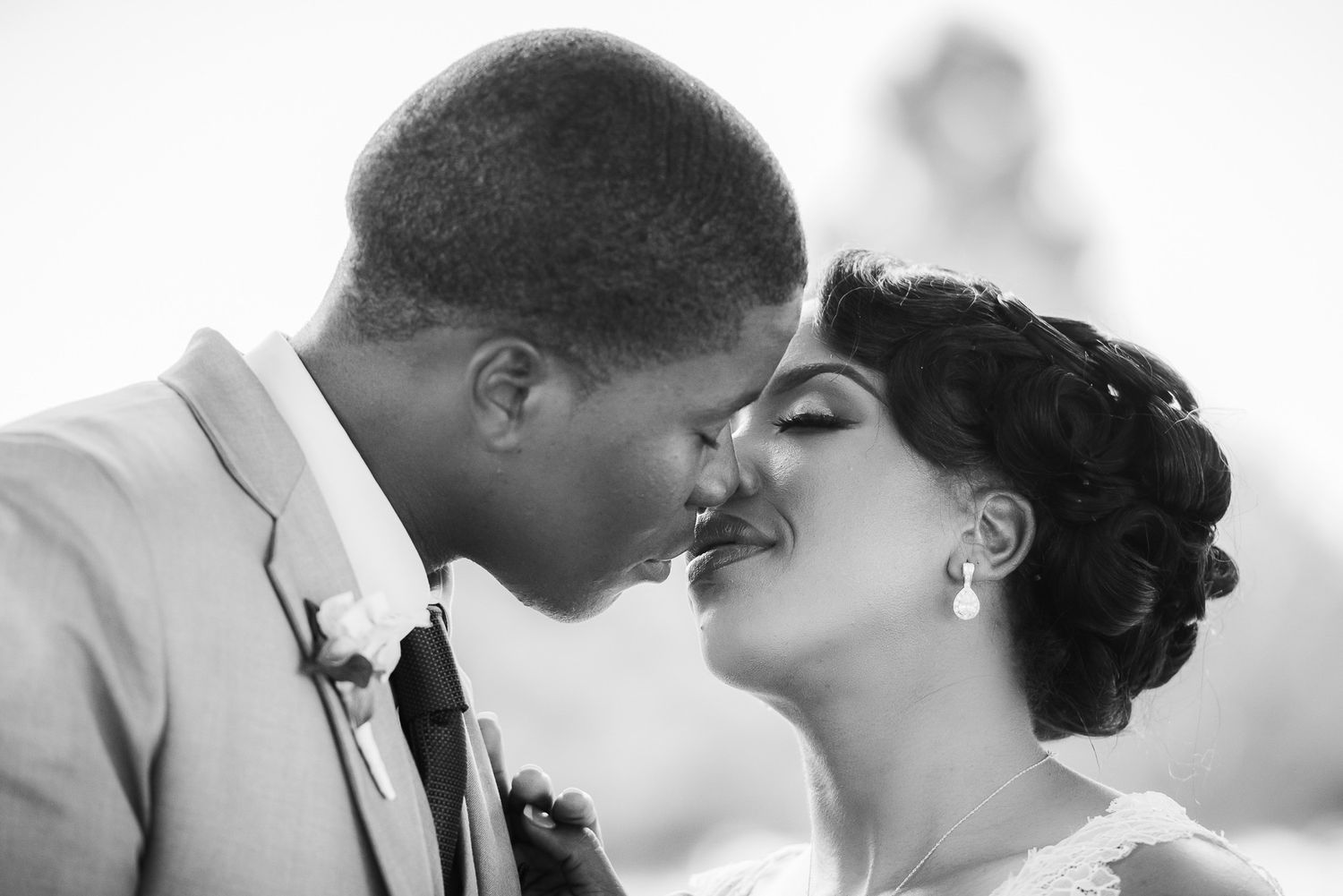 Intimate black and white close-up portrait of couple sharing tender moment.