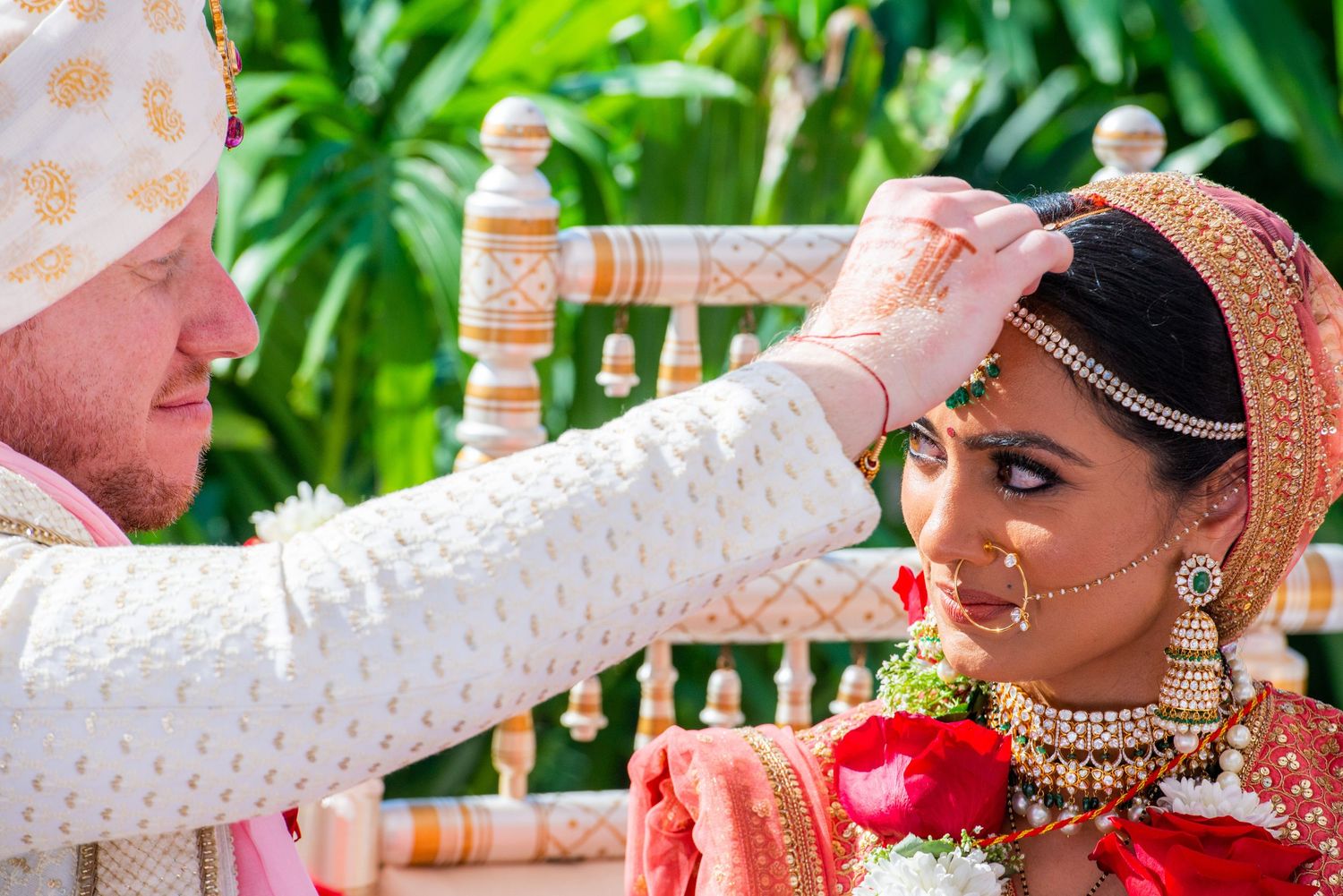 Traditional Indian wedding ceremony with ritual sindoor application.