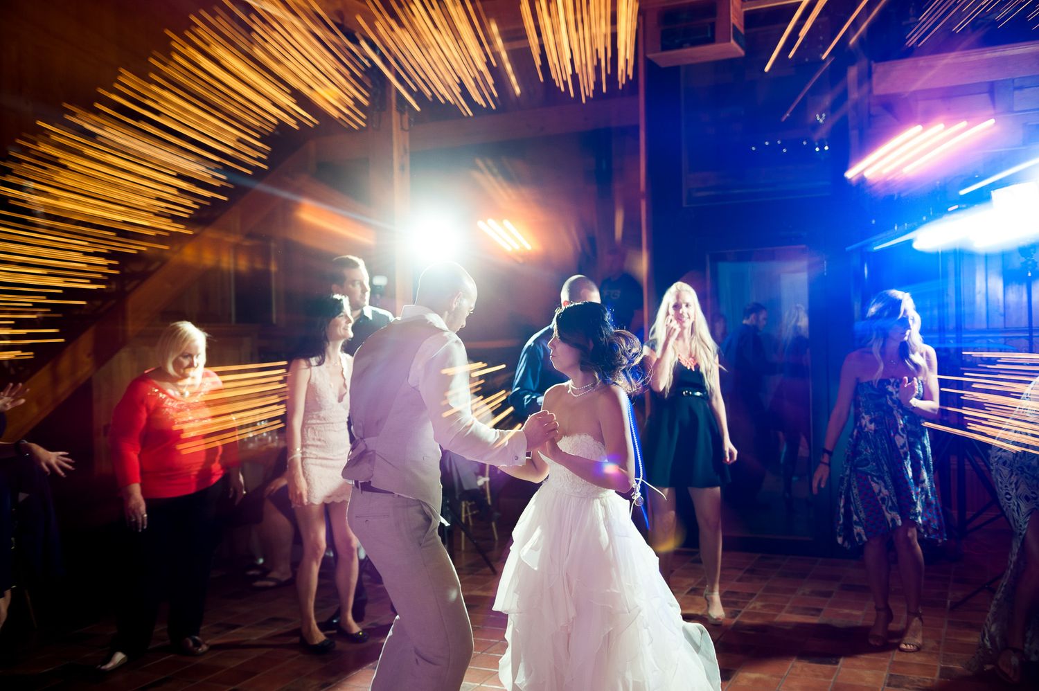 Wedding reception dance floor with motion blur and dramatic lighting effects.