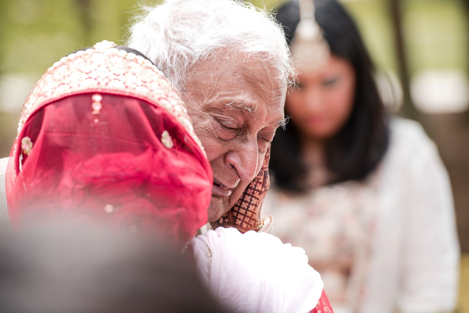 An emotional moment captured during a traditional wedding ceremony celebration.