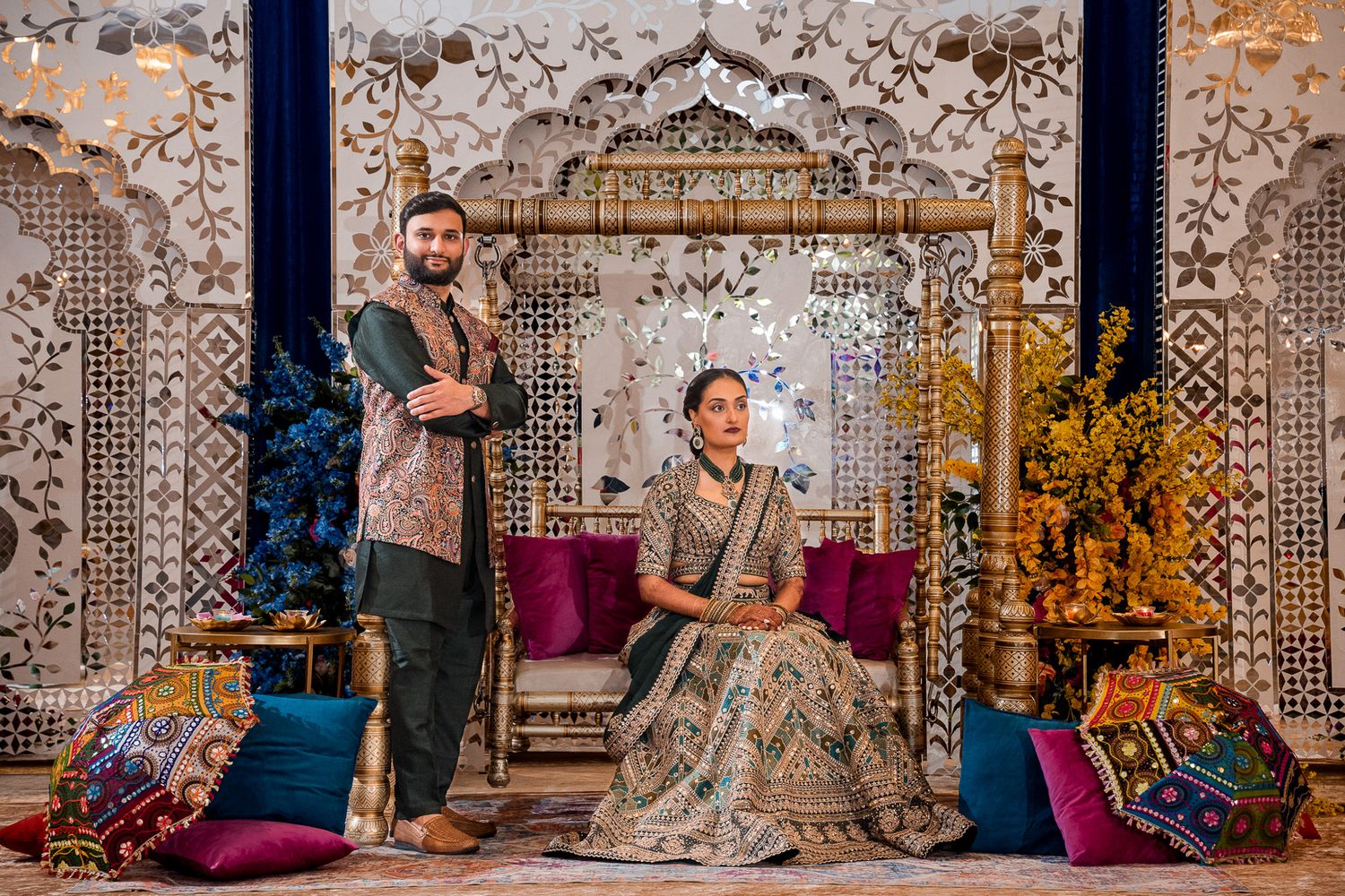 Elegant wedding portrait with ornate backdrop and traditional formal attire.