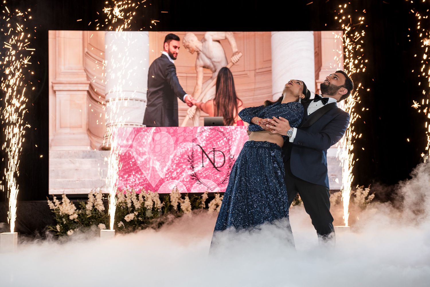 Celebratory event with decorative pink banner and special effects fog creating a magical atmosphere.