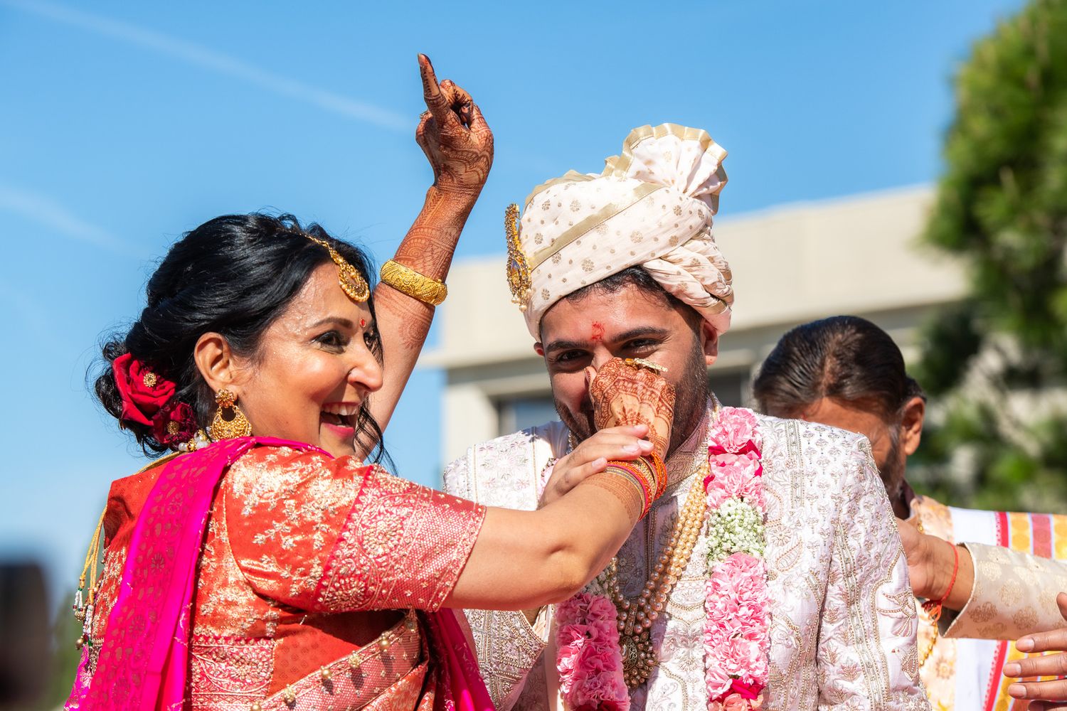 Playful moment during Holi celebration at an Indian wedding.