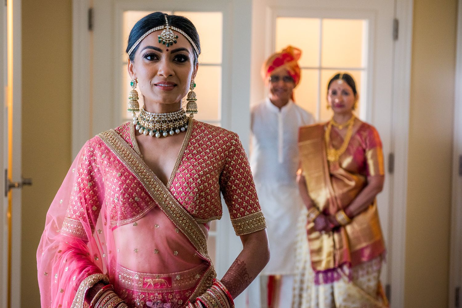 Traditional Indian bridal preparations showing elegant pink lehenga and cultural attire.