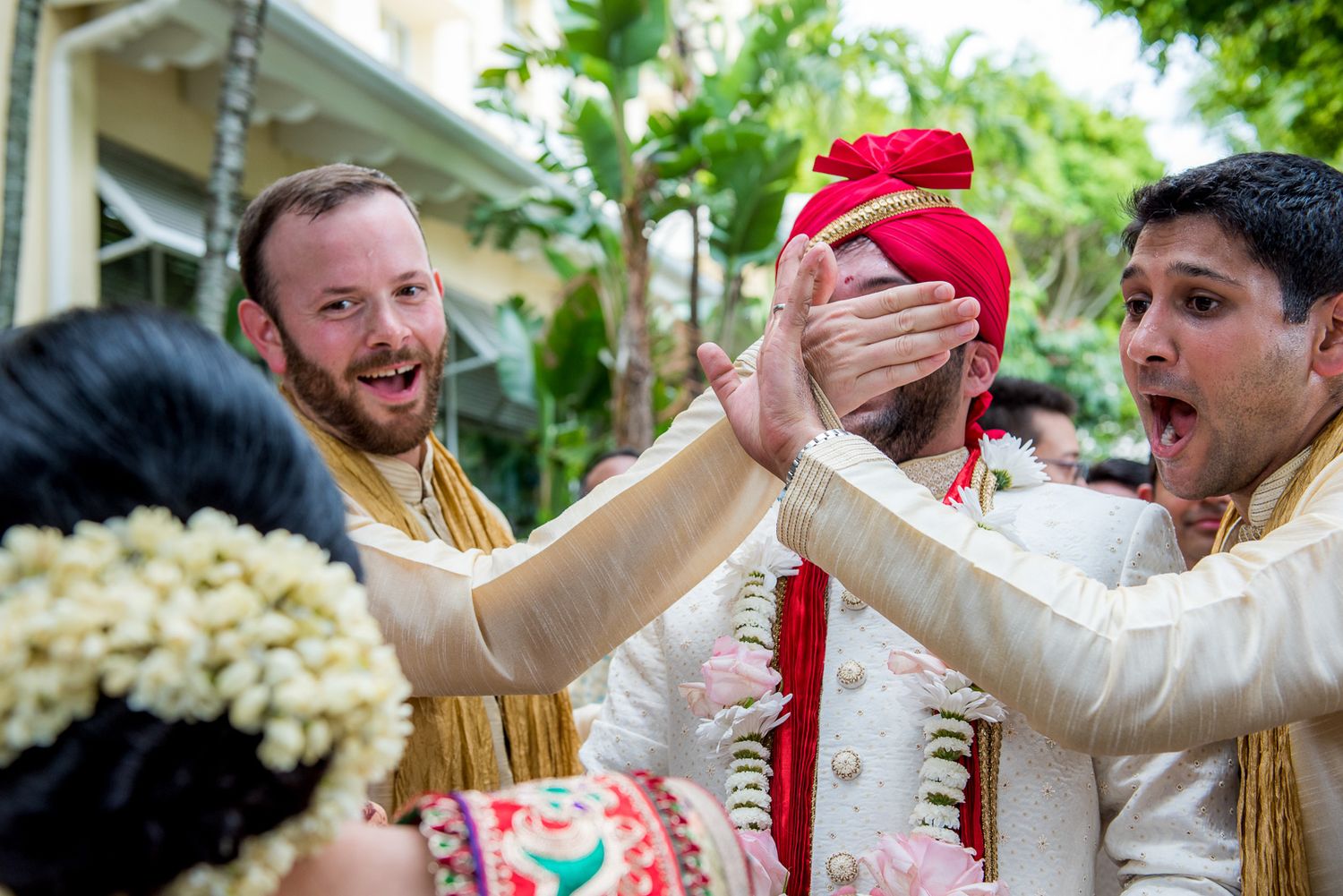 Jubilant celebration moment during an Indian wedding ceremony with guests in traditional attire.