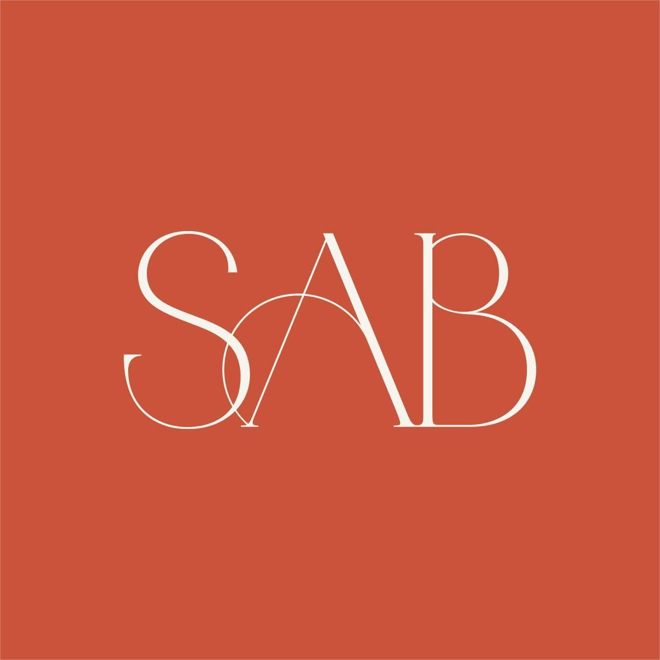 Modern logo design featuring the letters SAB in elegant white typography on a terracotta red background.