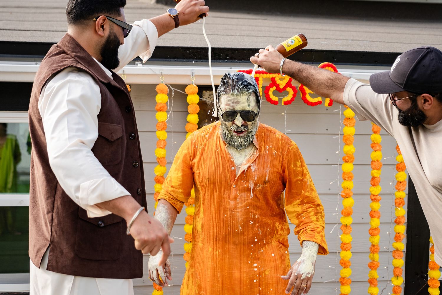 Traditional Haldi ceremony with turmeric paste being applied during pre-wedding ritual.
