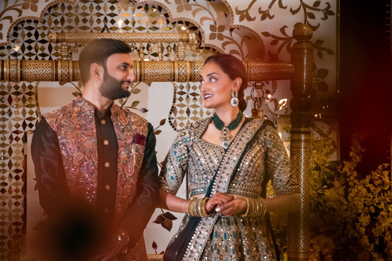 Artistic wedding portrait with moody lighting and traditional formal wear.