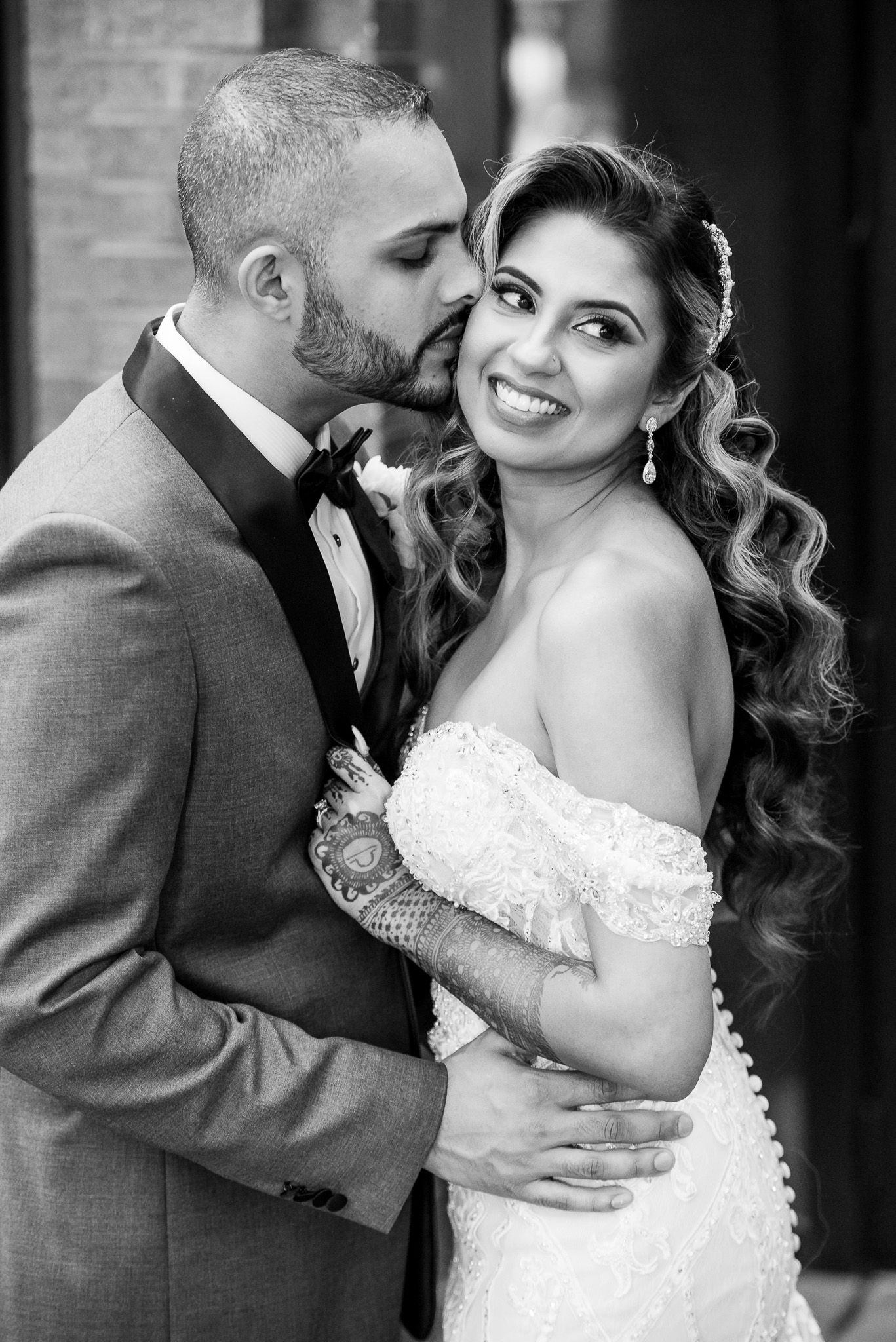 Romantic black and white portrait of newlyweds sharing an intimate moment.