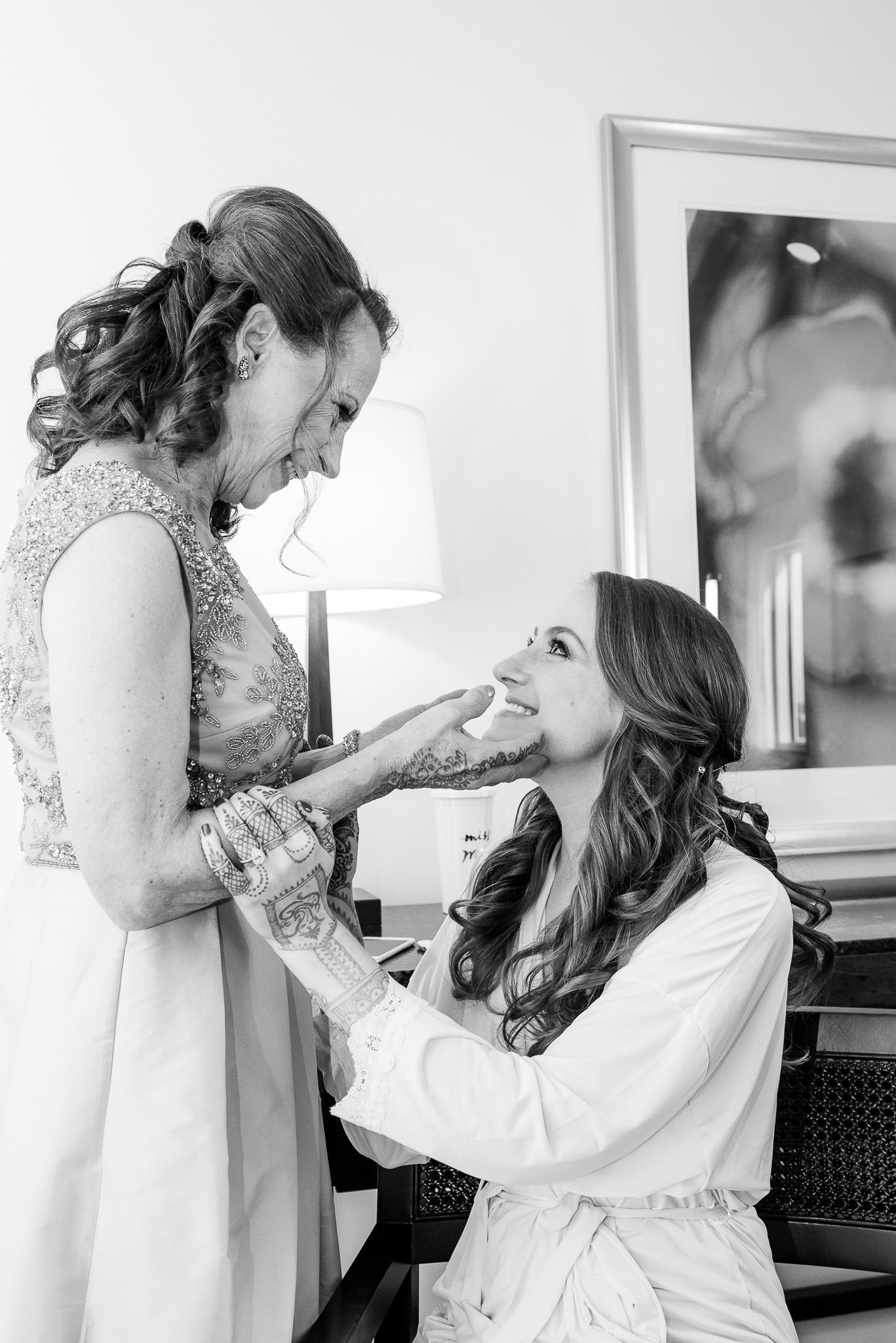 Emotional black and white moment between two women during wedding preparations.
