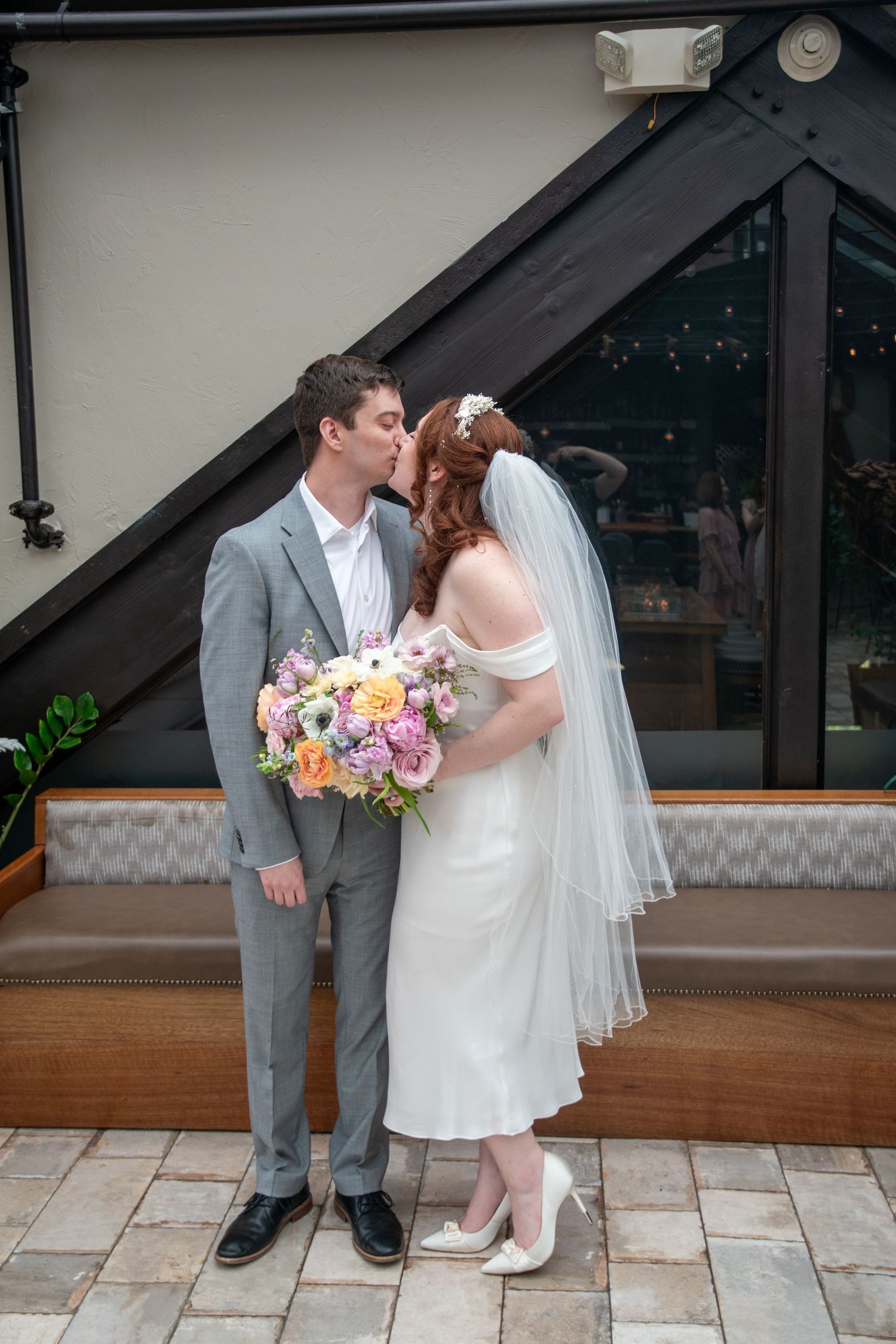 Couple sharing romantic moments on an outdoor stone patio.