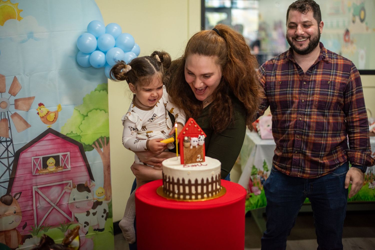 A birthday celebration with cake and decorations in a cheerfully decorated room.
