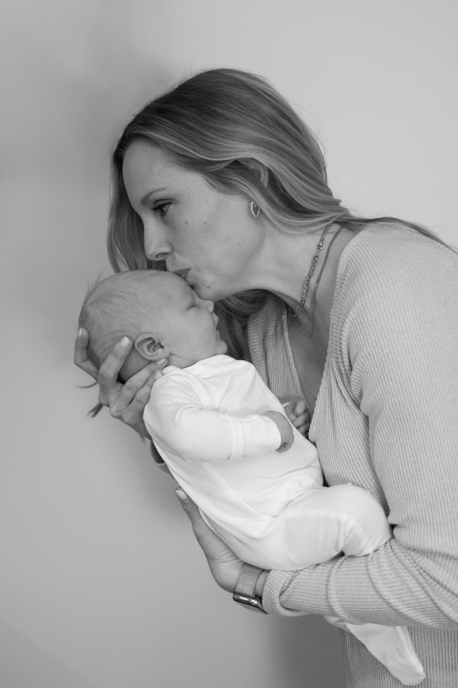 Tender black and white portrait showing gentle maternal bonding moment.