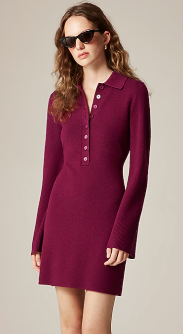 Burgundy long-sleeve polo dress with button placket and collar worn with dark sunglasses against neutral background.