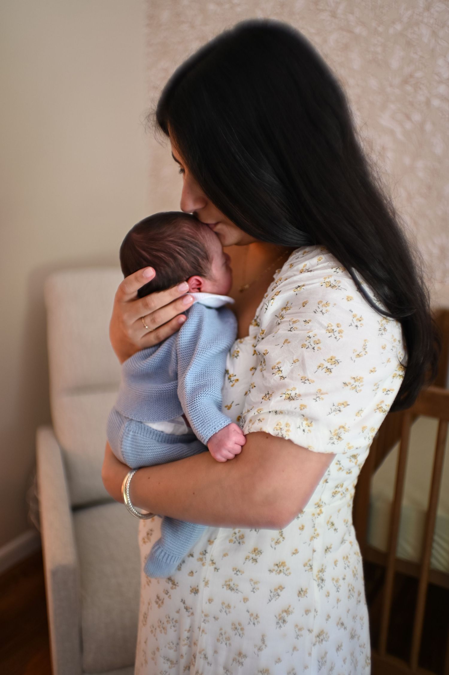 Intimate family moment with newborn baby in soft natural light.