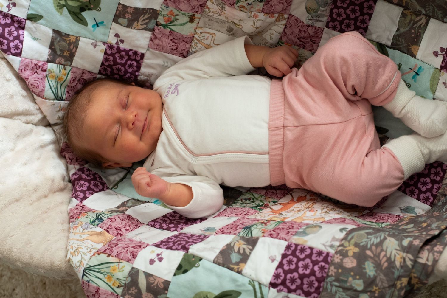 Peaceful nap time scene with cozy quilted blanket in soft lighting.