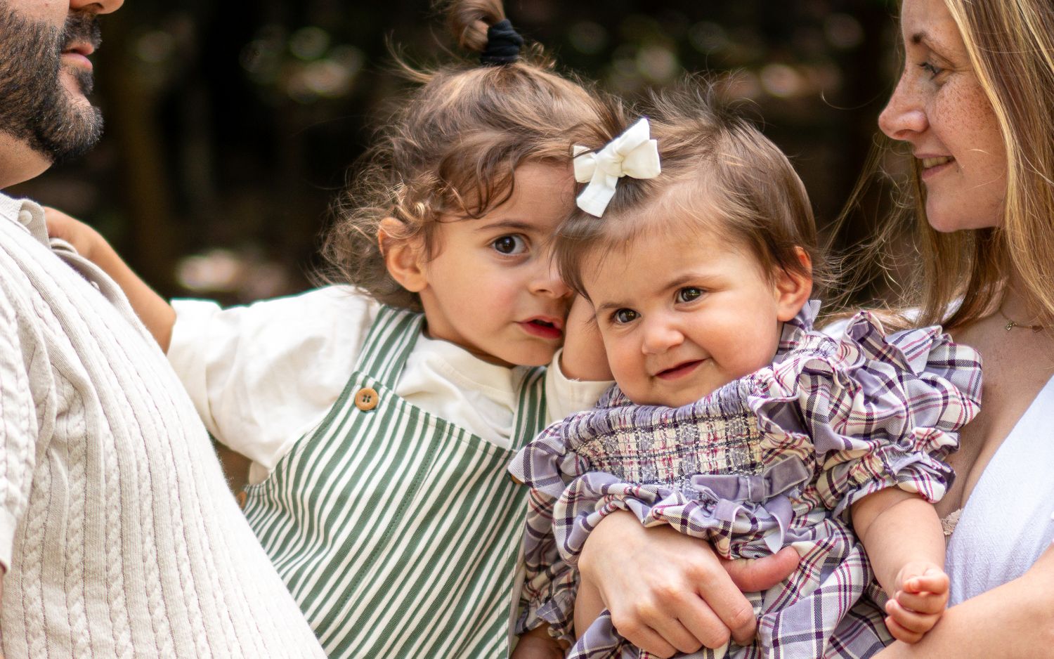 Family members enjoying a tender moment together in a casual outdoor setting.