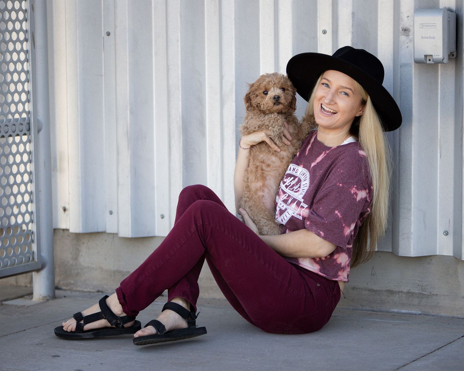 Portrait of entrepreneur with a modern, casual look with her dog