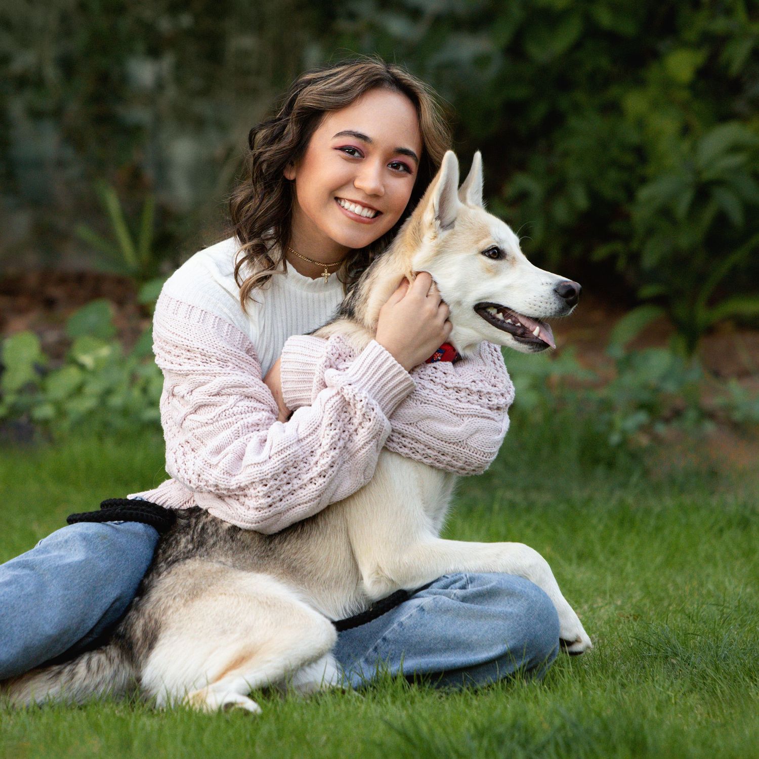Cute photo of high school senior girl with her dog outdoors