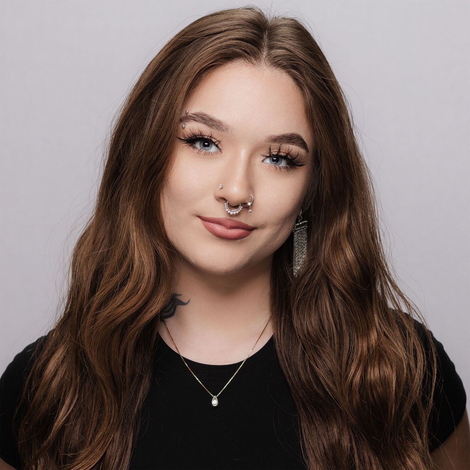 Close-up headshot with confident expression and clean background