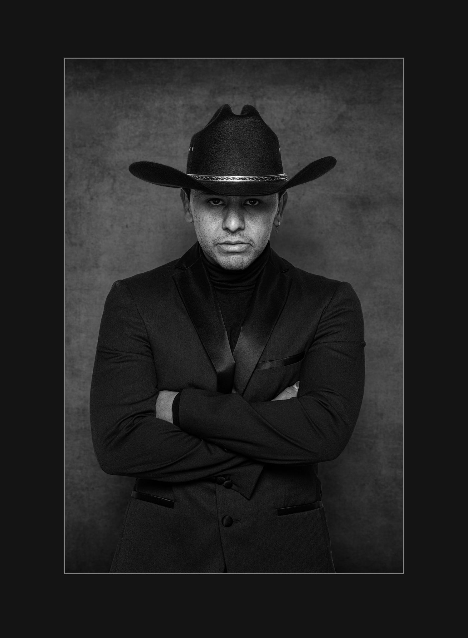 Award-winning image of man wearing a black hat and jacket