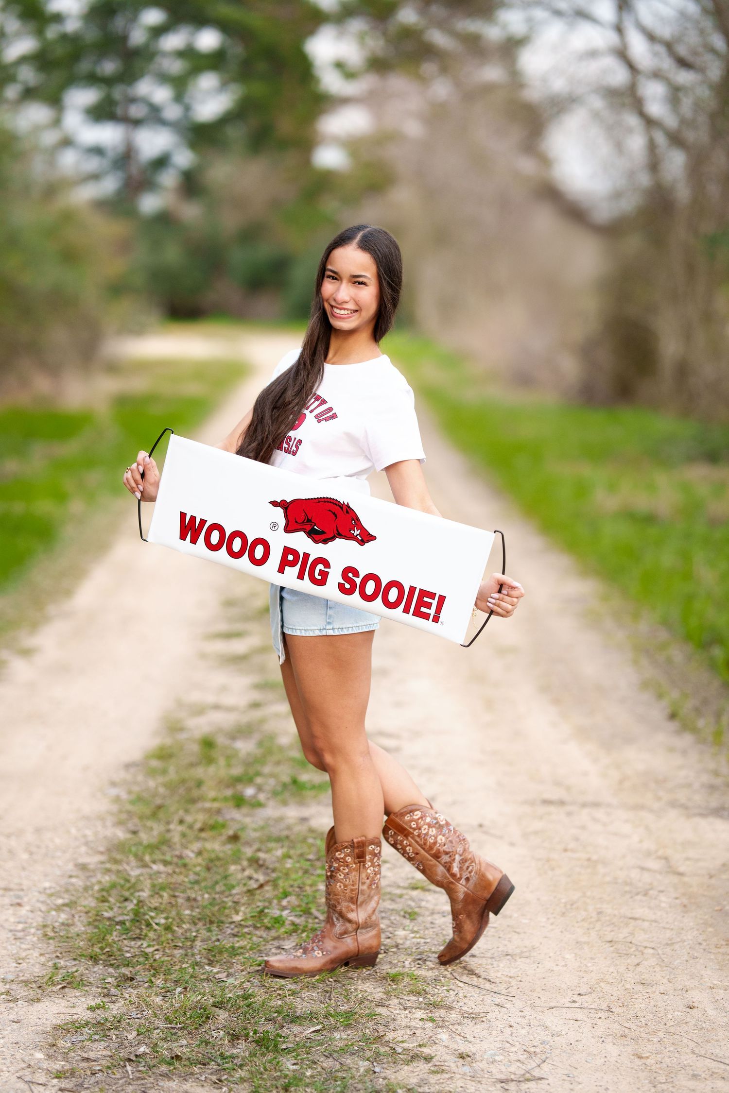 Arkansas college reveal images.  Posing with acceptance banner for senior photos.  The woodlands senior photographer college session