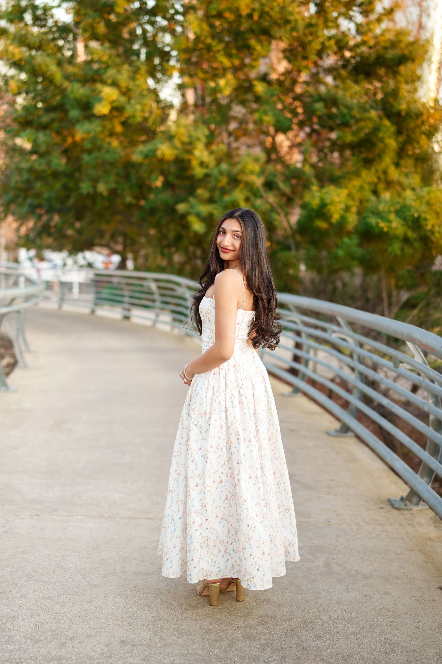 houston senior photos on a walkway bridge.  the woodlands senior photographer with a girl in a long dress