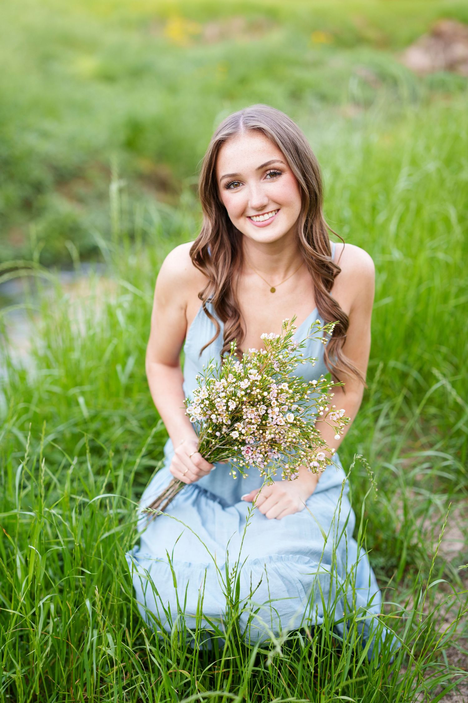 senior girl in a field with flowers