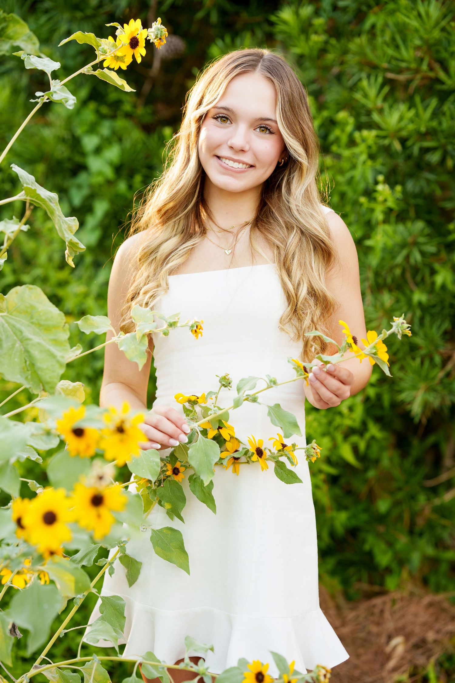 The Woodlands senior photographer.  senior girl in a garden with flowers