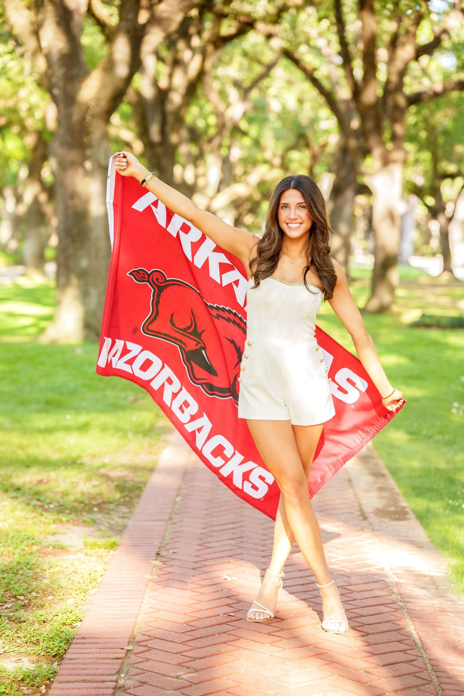 Arkansas college reveal images.  Posing with college flag for senior photos.  The woodlands senior photographer
