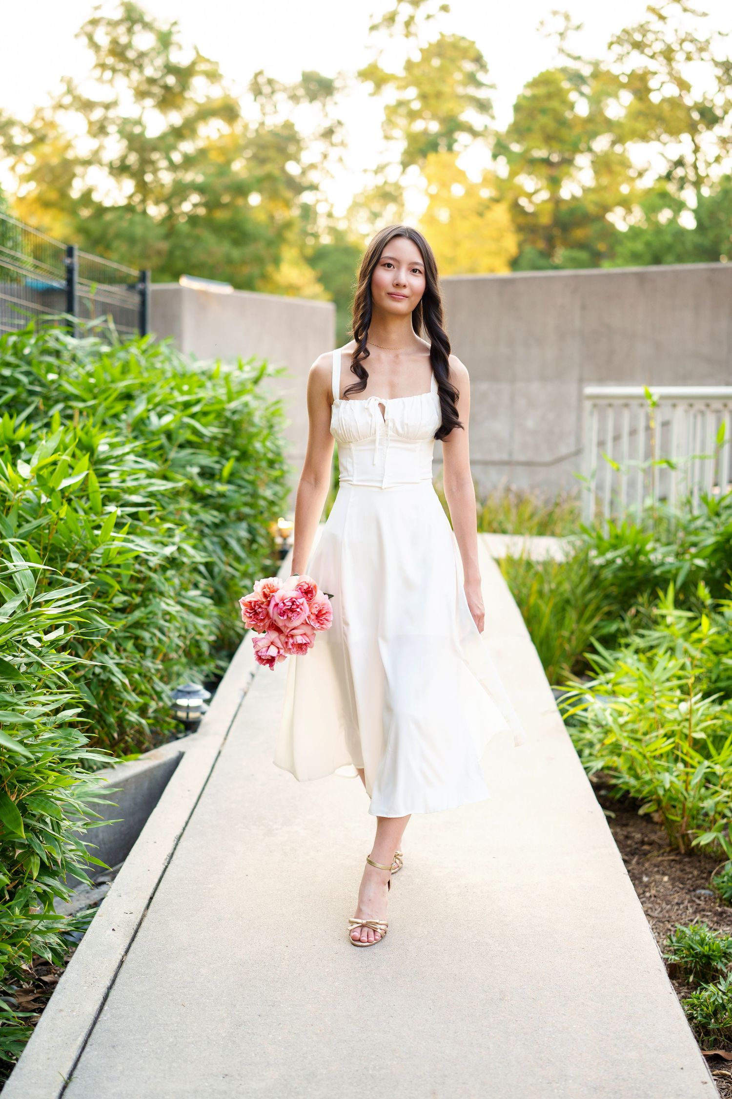 senior girl with flowers in a garden.  woodlands senior photographer.