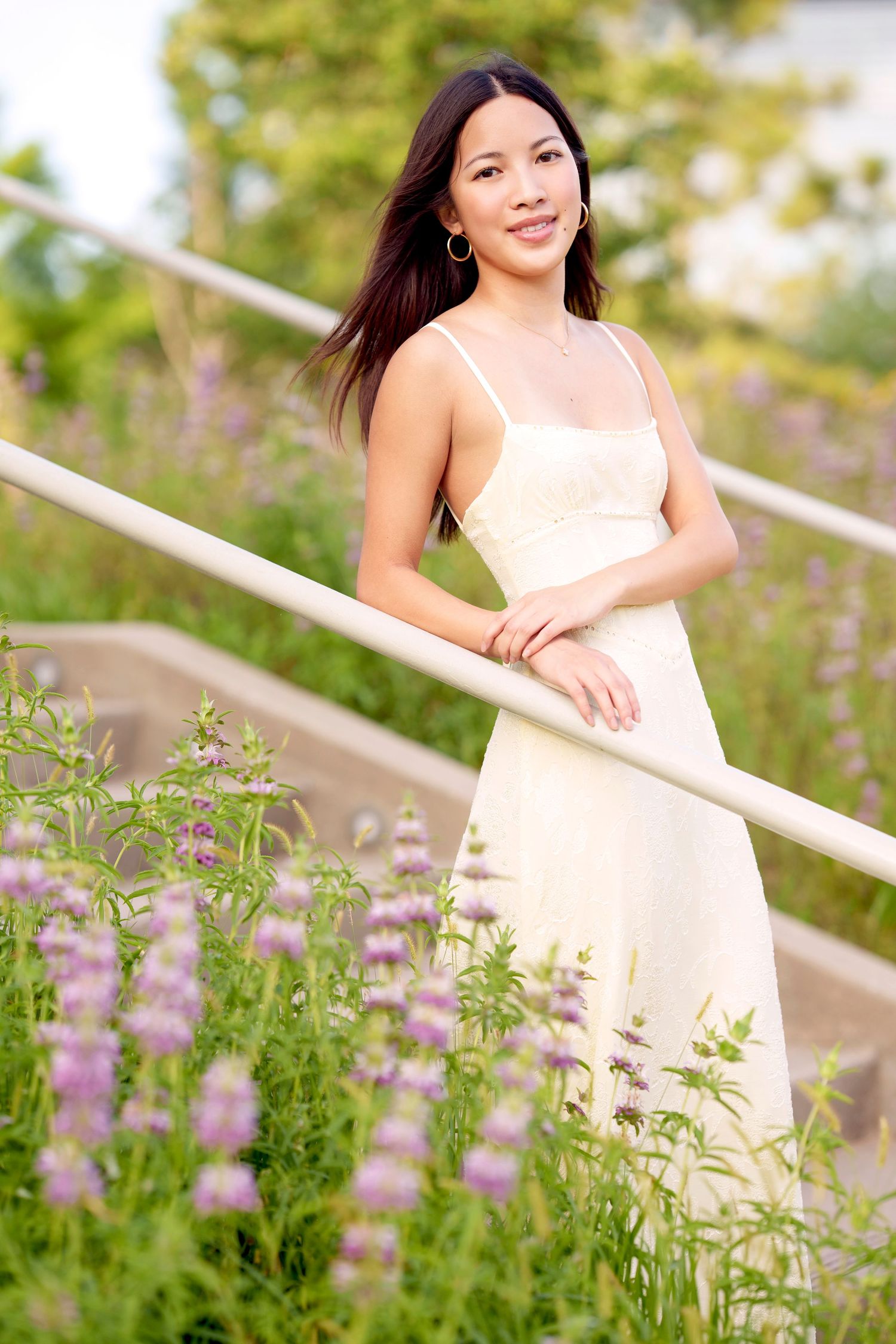 senior girl photo in the woodland in a long dress among flowers