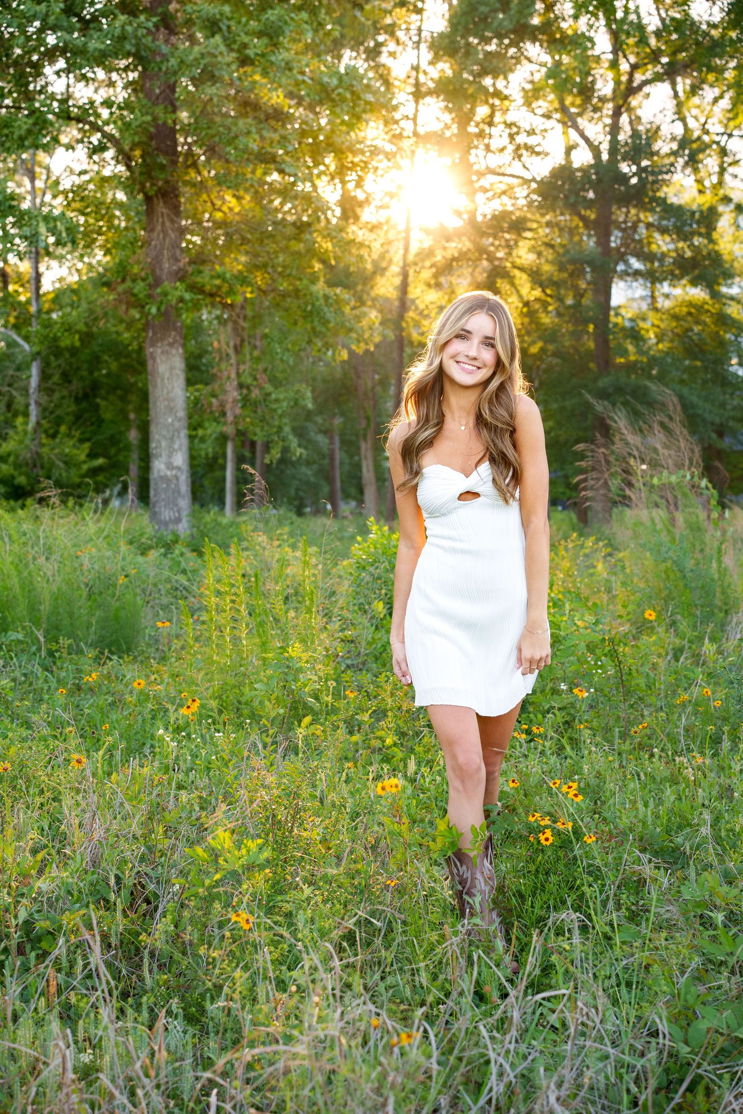the best time to take senior photos is sunset in a golden field with tall grass in the spring