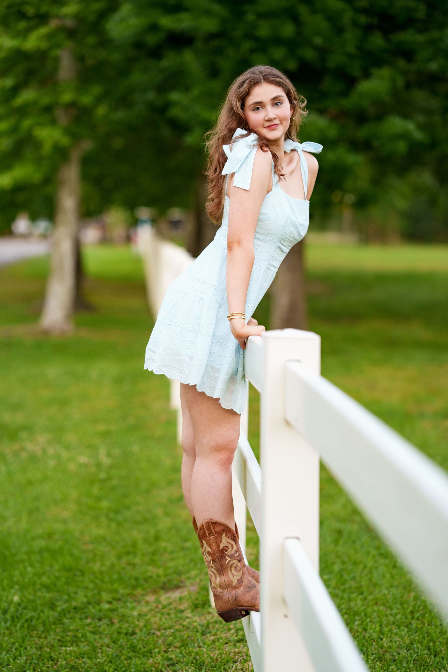 The Woodlands senior photographer.  Senior girl on a fence.  White fence senior photos