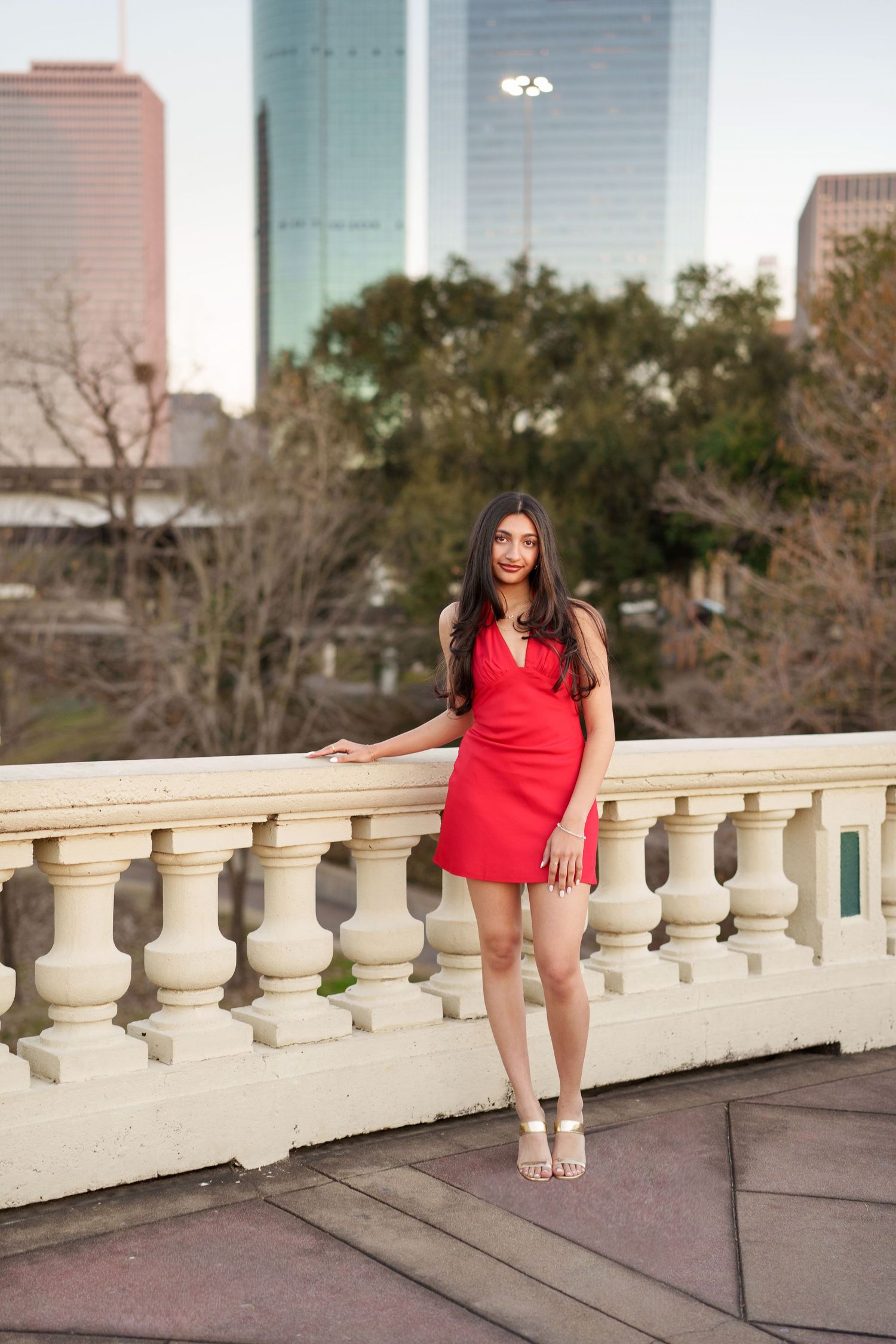 senior photos in houston.  the woodlands senior photographer.  houston skyline in the background with a white stone bridge