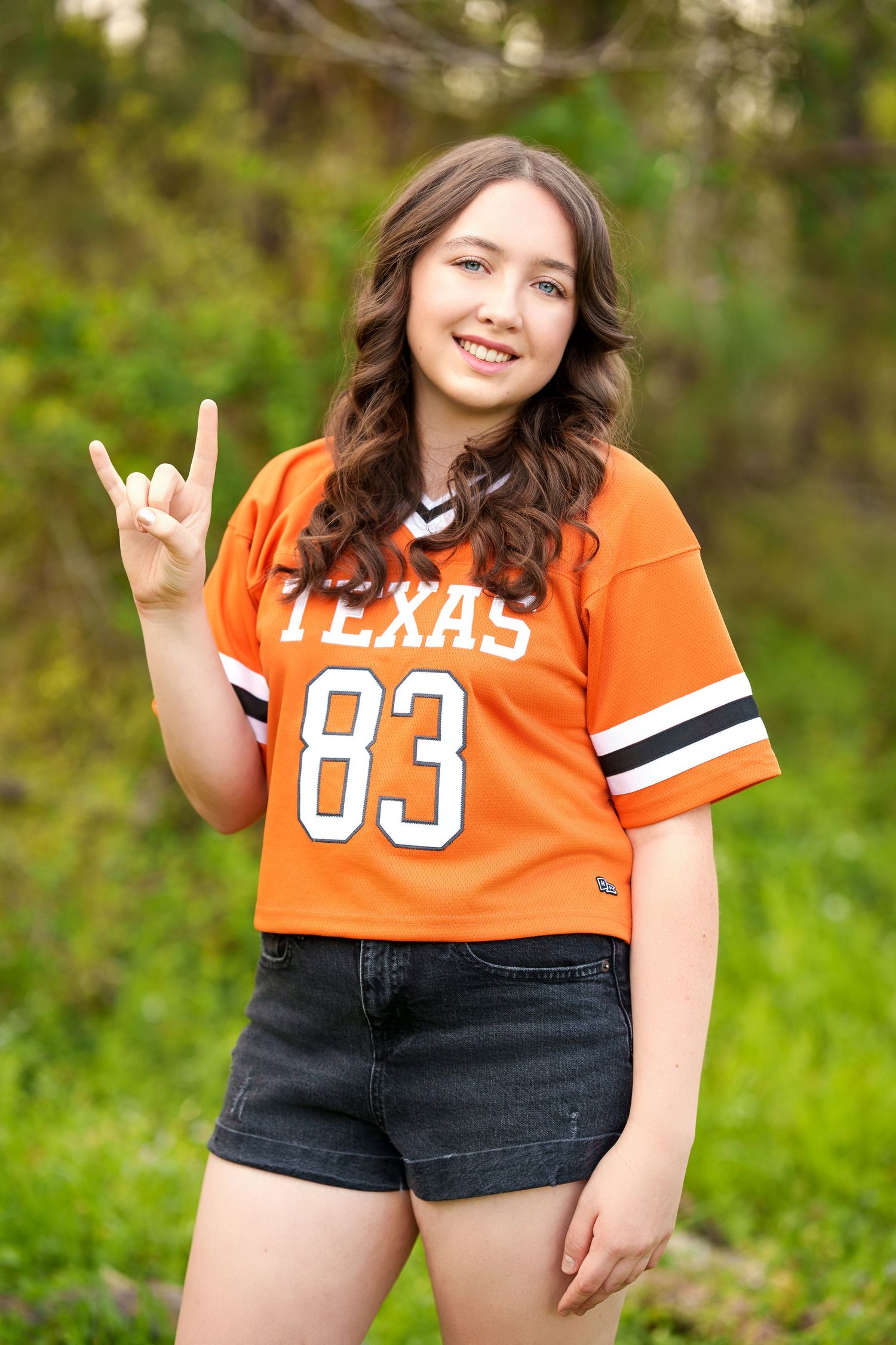 UT college reveal images.  Posing with college gear for senior photos.  The woodlands senior photographer college session