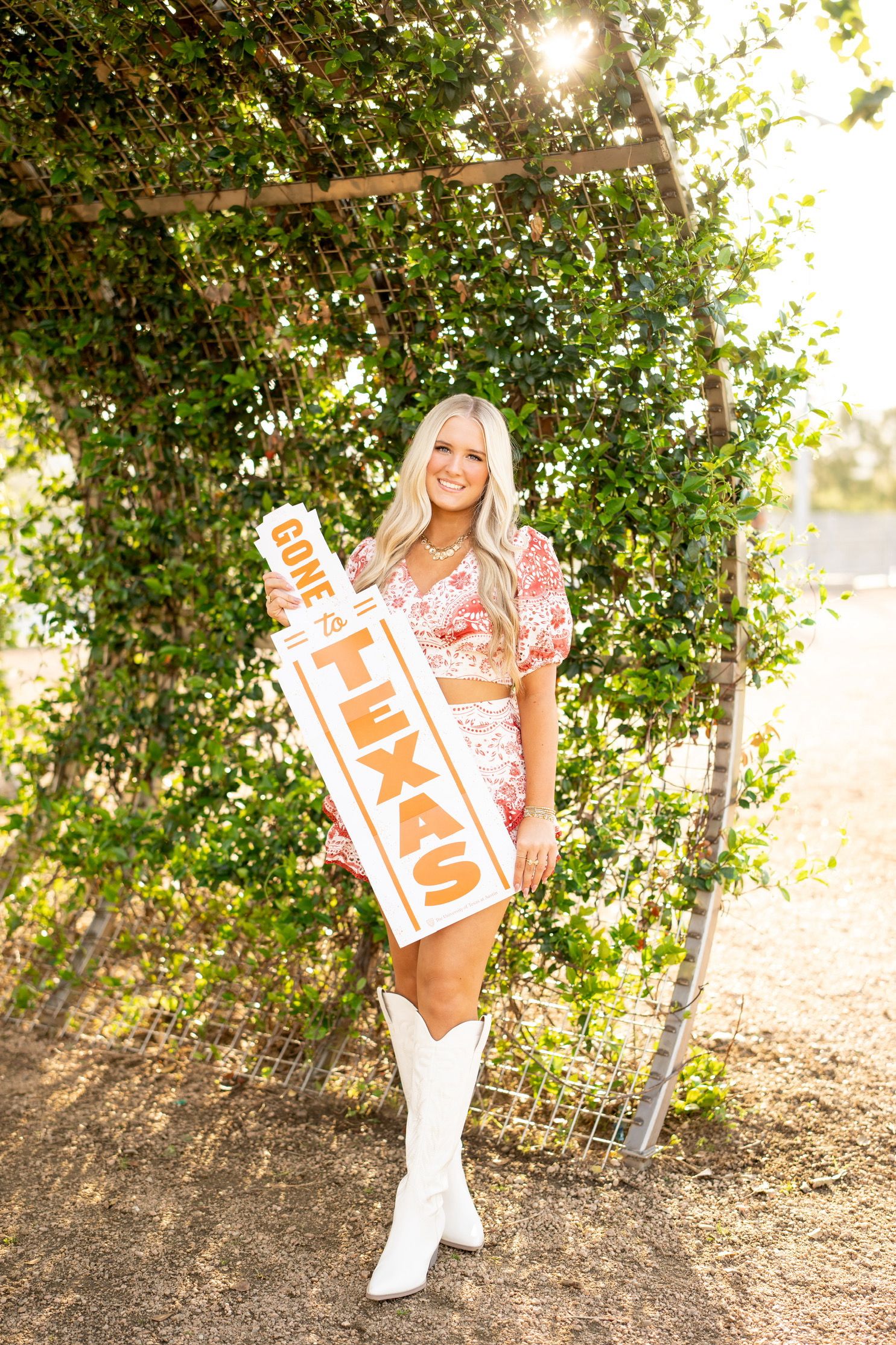 senior girl holding a UT acceptance banner