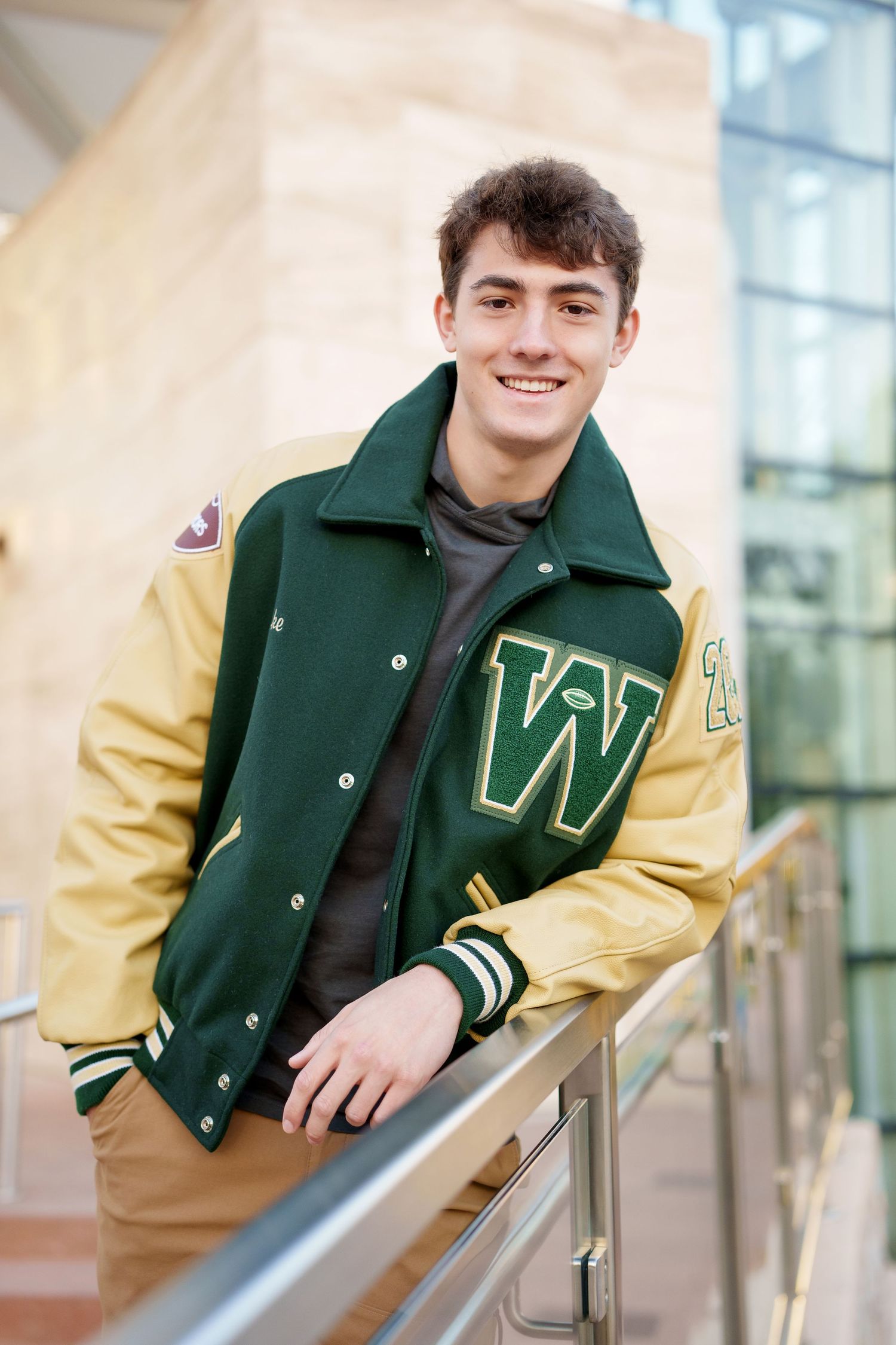 letterman jacket senior guy photo.  Woodlands christian academy athlete in a letterman jacket.