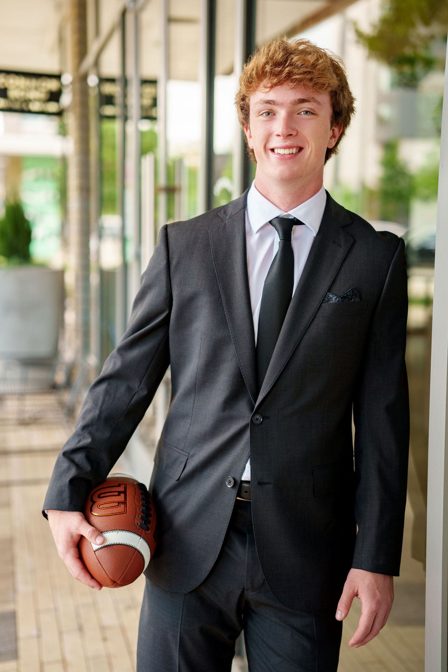 football player in a suit.  the woodlands and tomball football senior photos