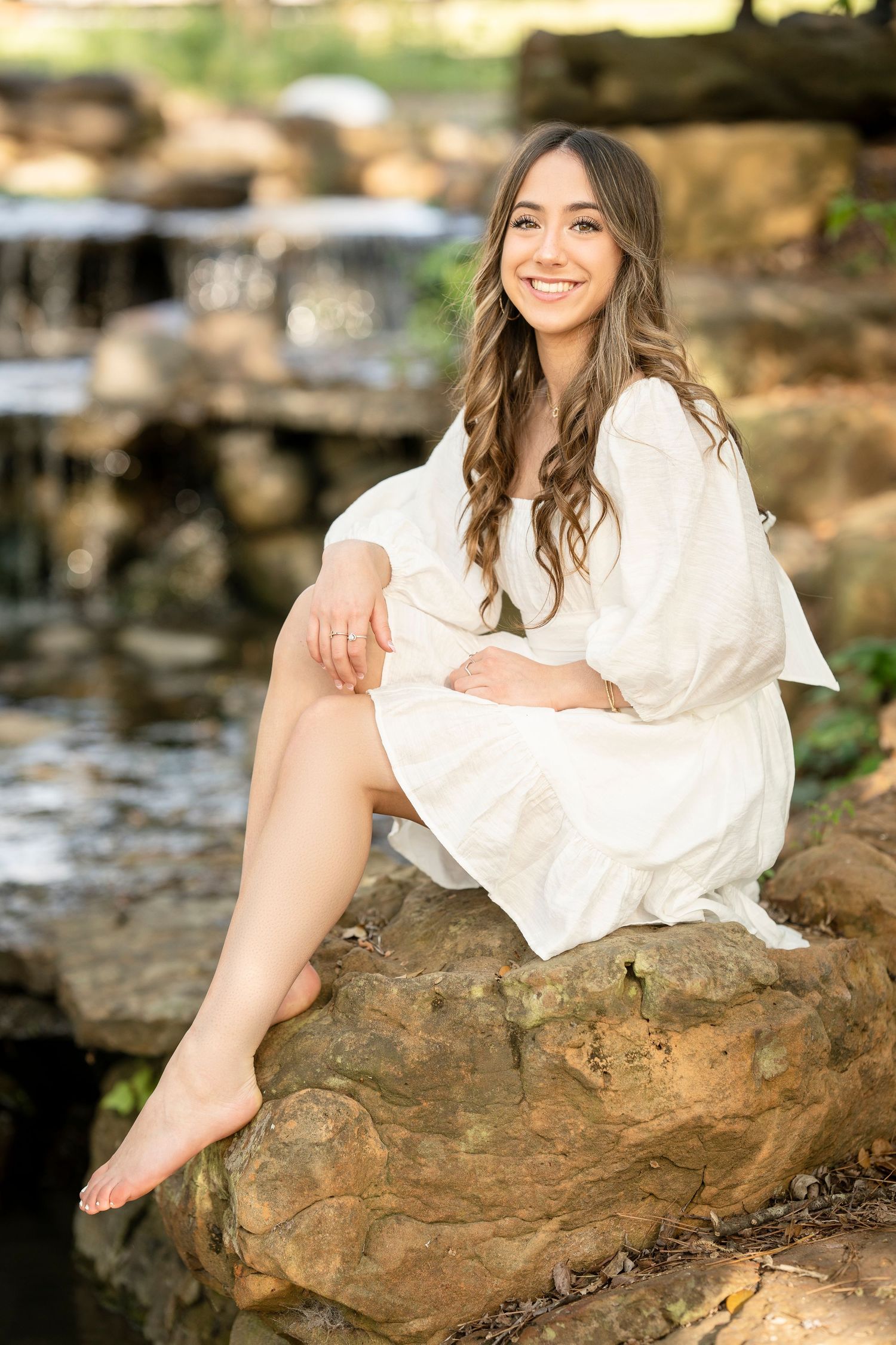 senior girl at a waterfall in the woodlands, nature senior session.