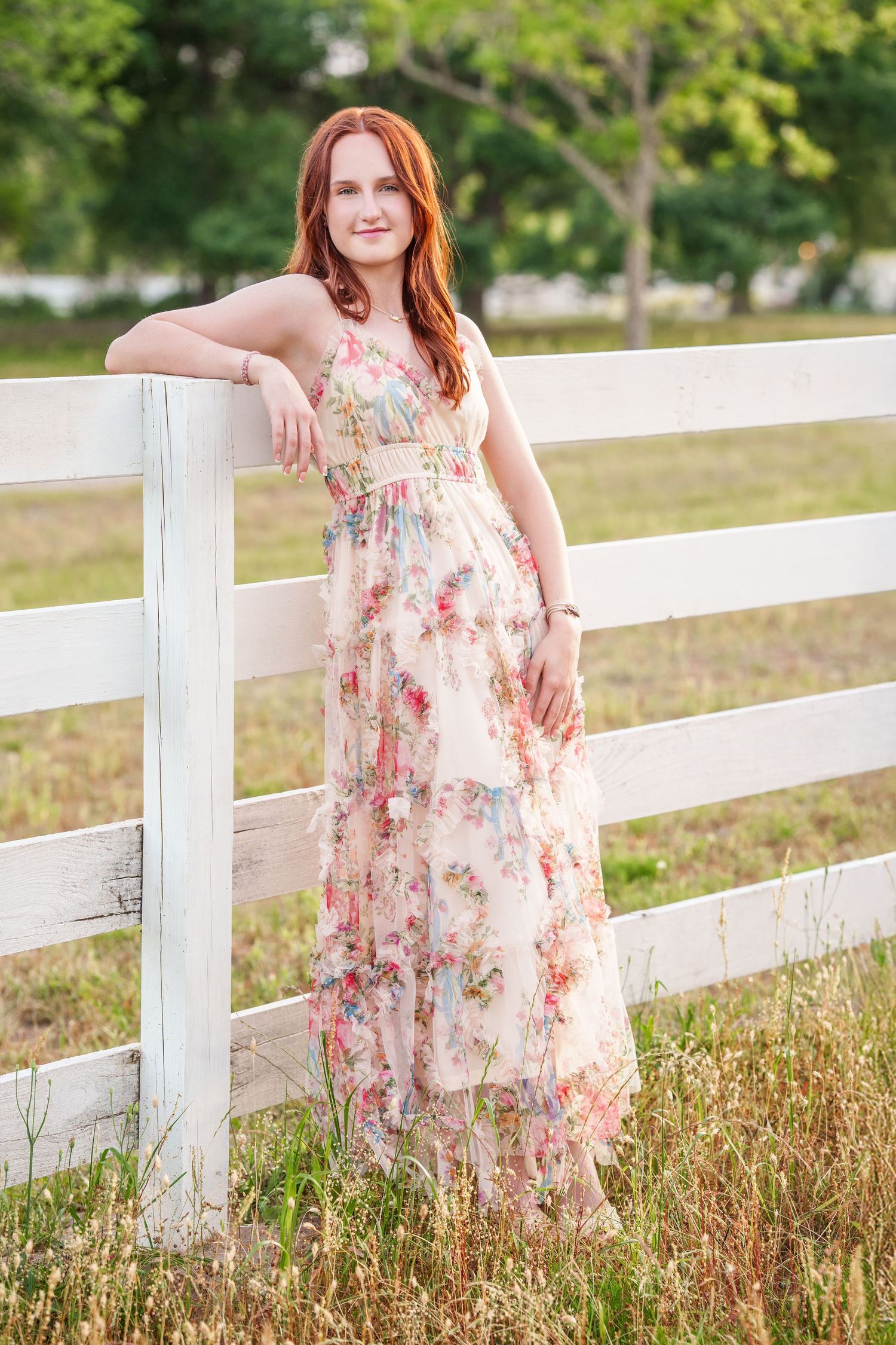 Senior girl on a farm with a white fence photographer in the woodlands,  Spring summer senior photos.