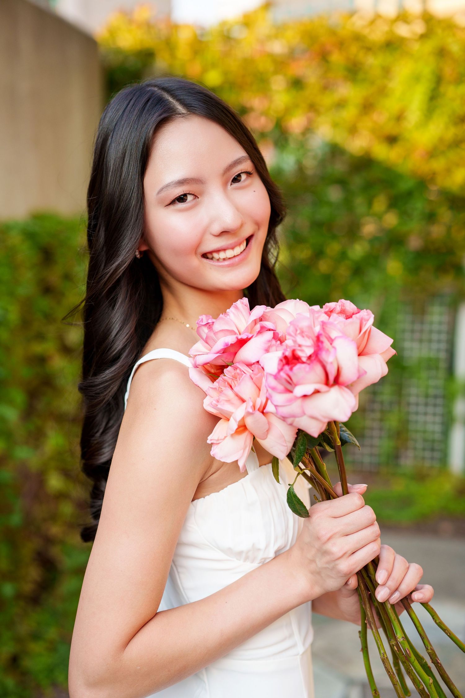 senior girl with flowers in the woodlands