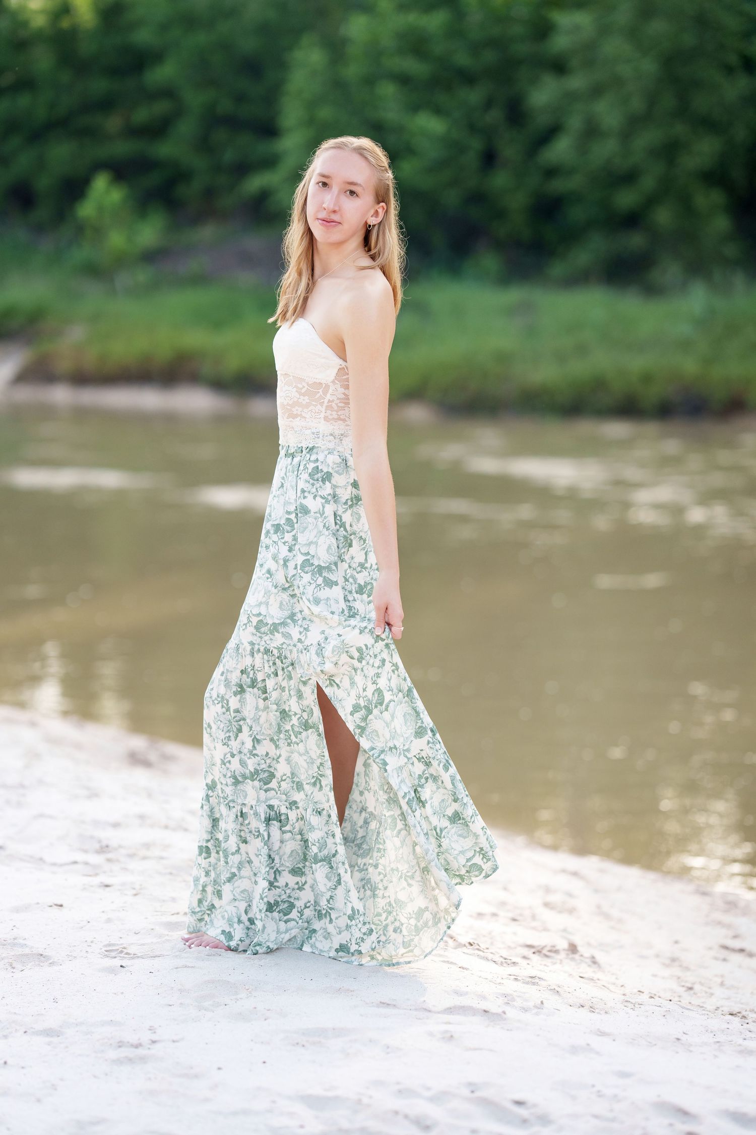 senior girl in a creek with sand