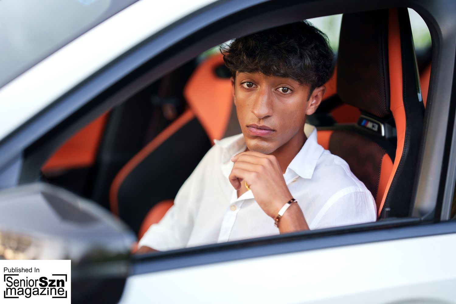 Senior photographer in the Woodlands.  Senior guy in a car